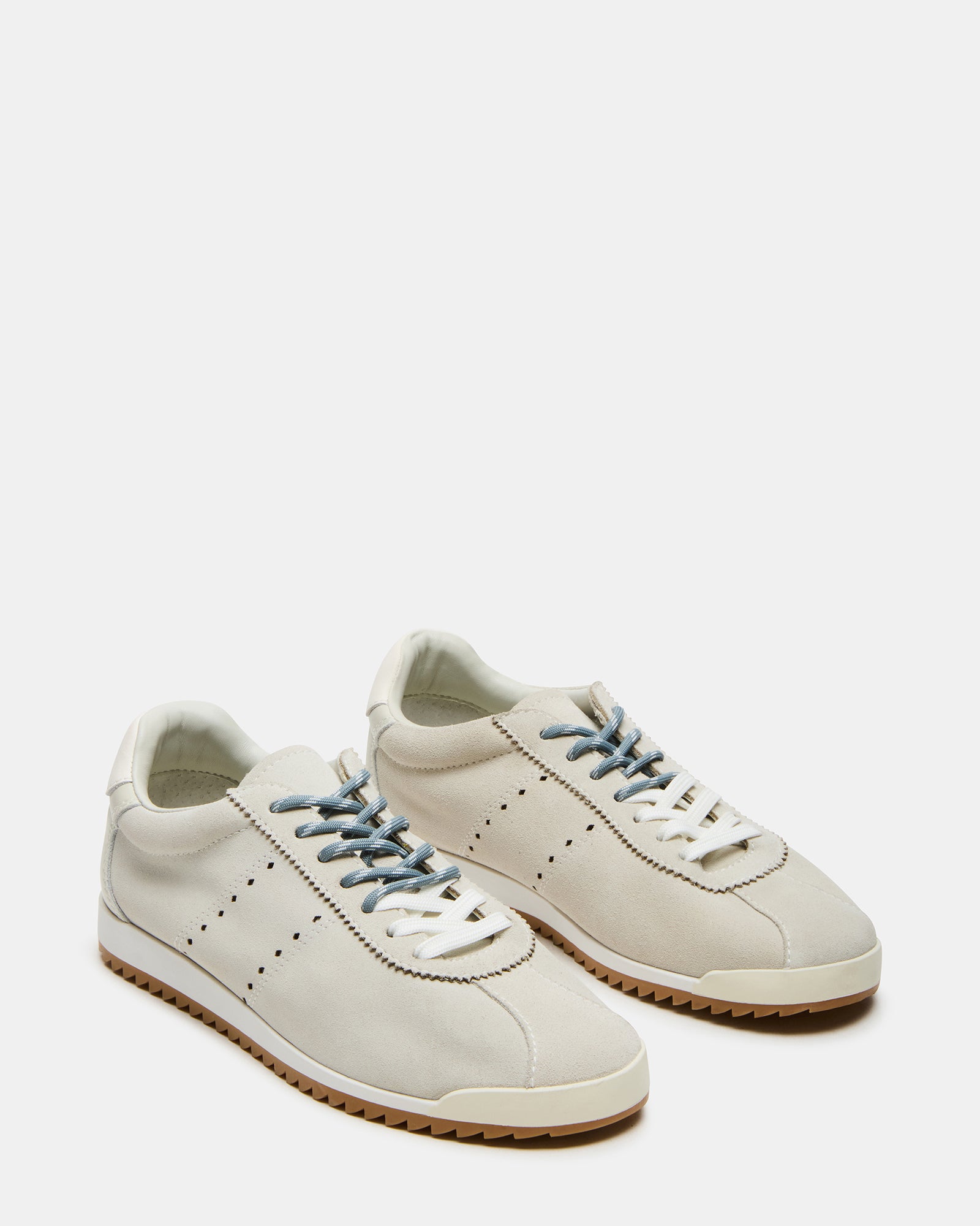 Mirage white sneakers on pavement, ideal for casual weekend outings