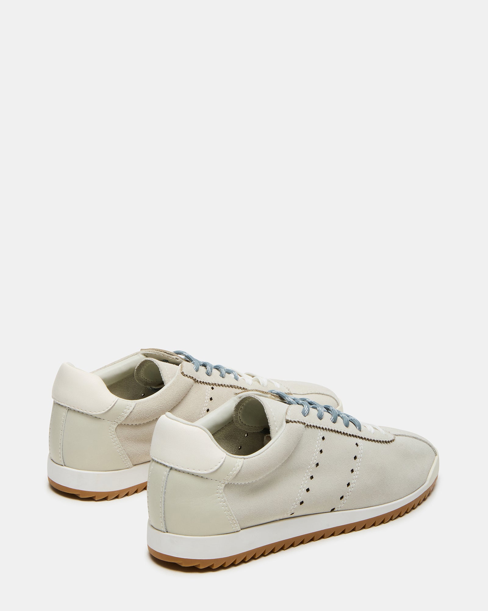 Mirage white sneakers on pavement, ideal for casual weekend outings