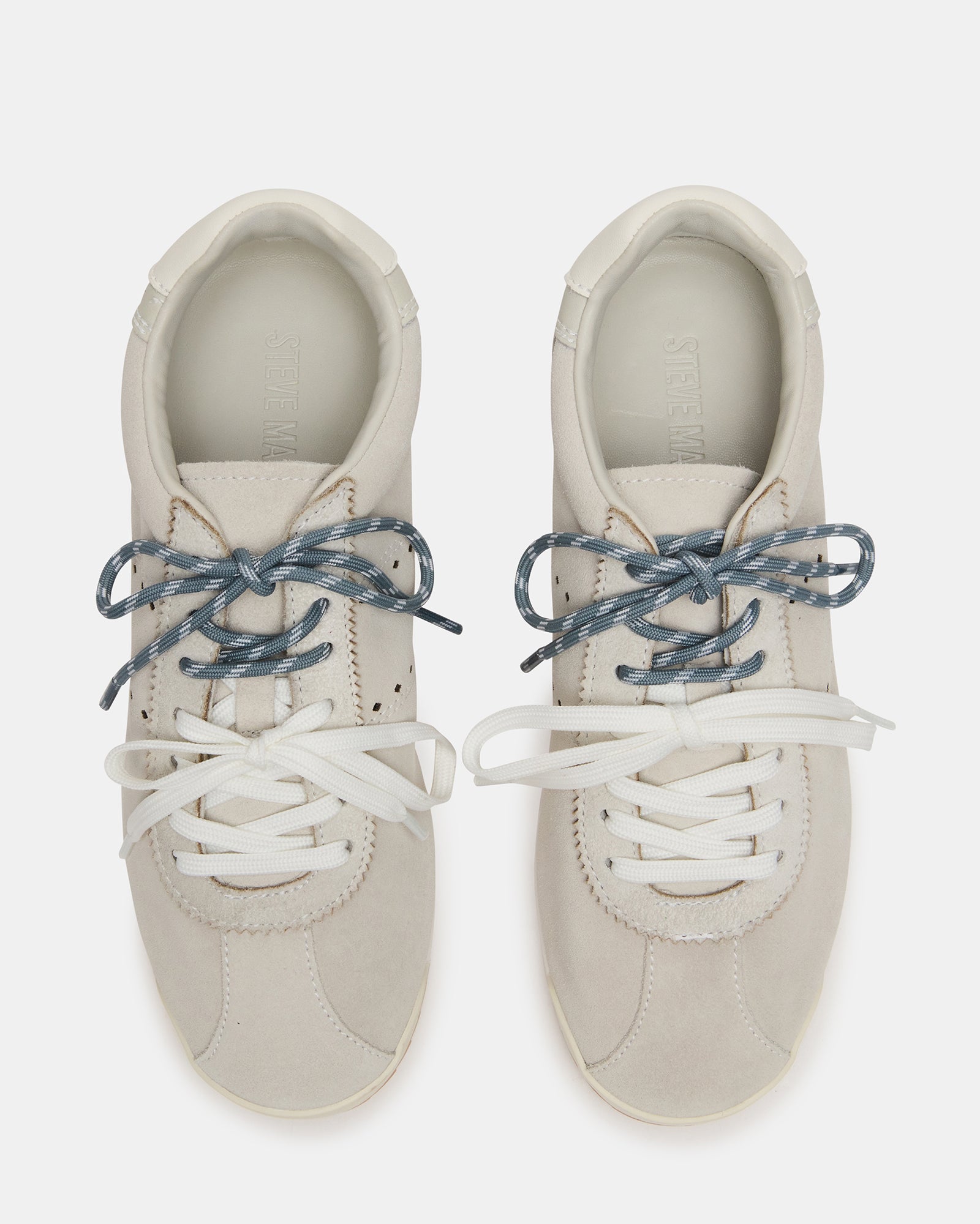 Top angle of lace-up sneakers showing dual lace colors and suede texture