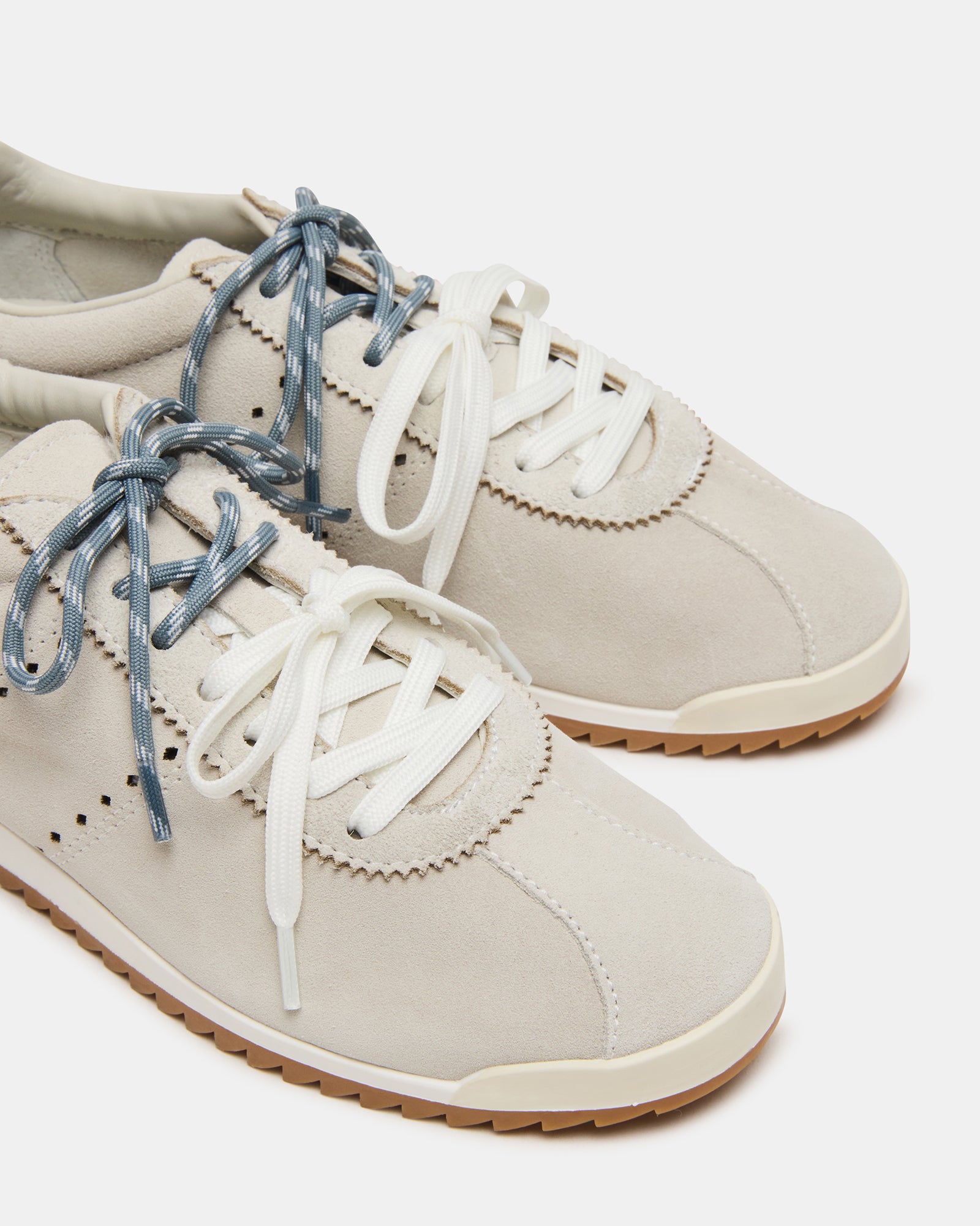 Mirage white sneakers on pavement, ideal for casual weekend outings