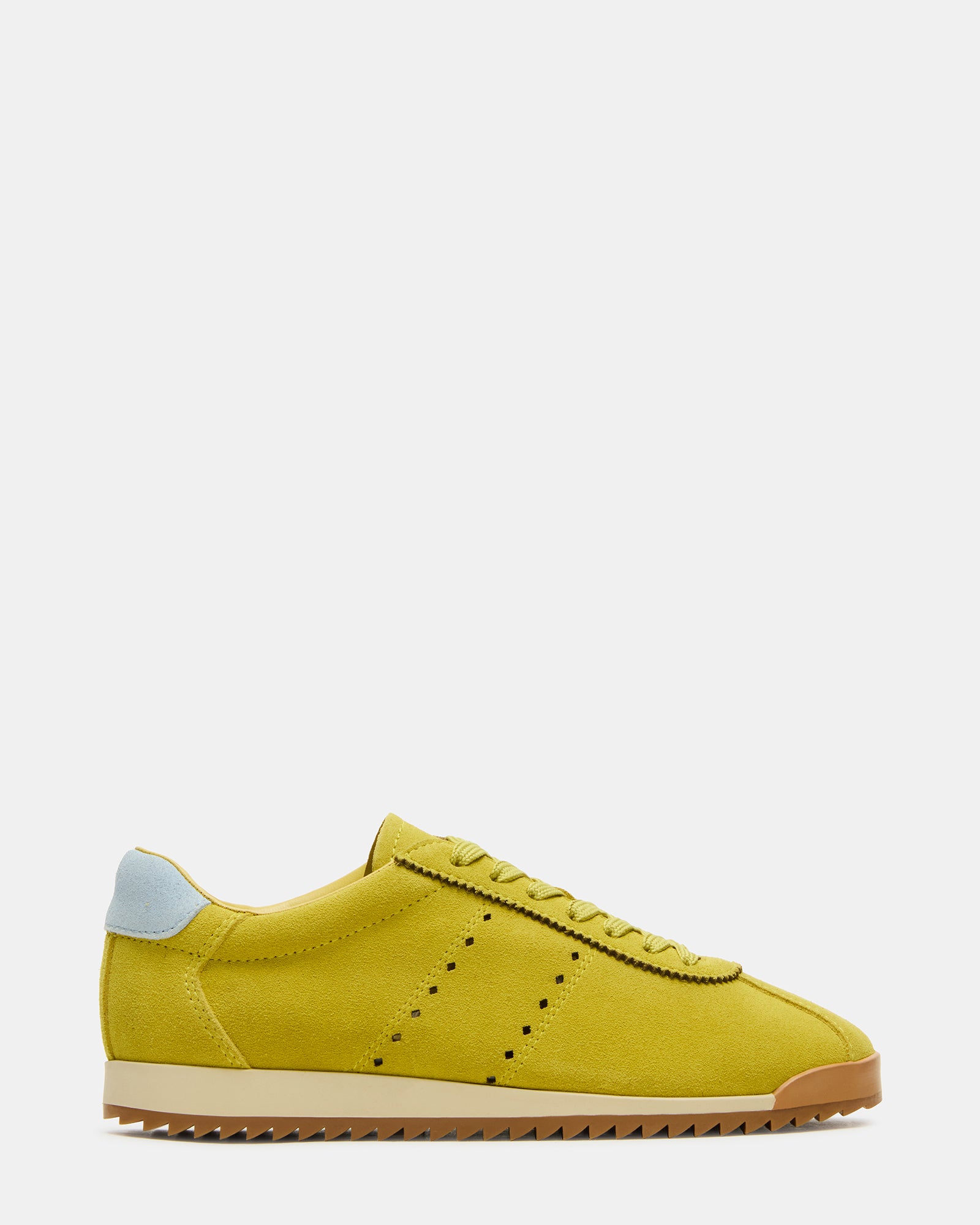 Side view of Mirage Lime low-top sneakers on a wooden floor