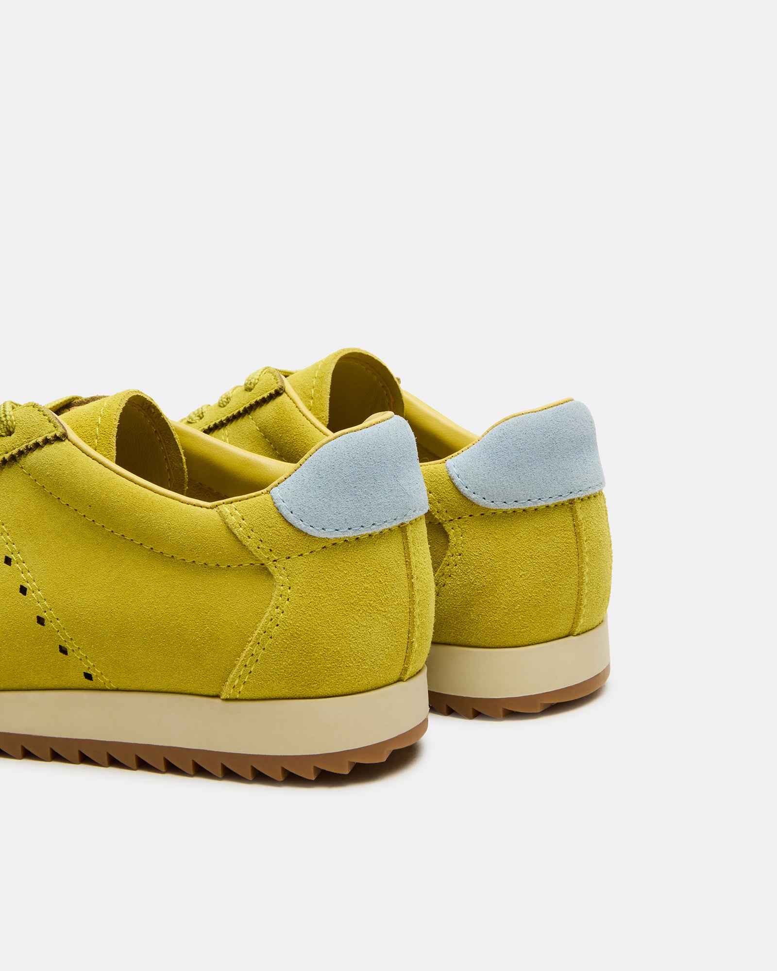 Mirage Lime sneakers paired with casual attire in a bright outdoor setting