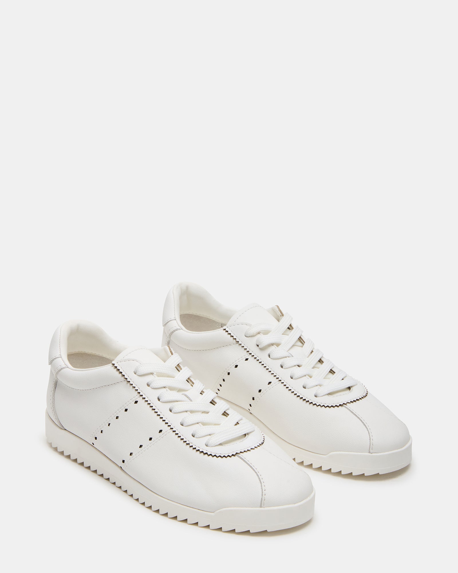 Mirage low-top sneakers in a casual outdoor setting.