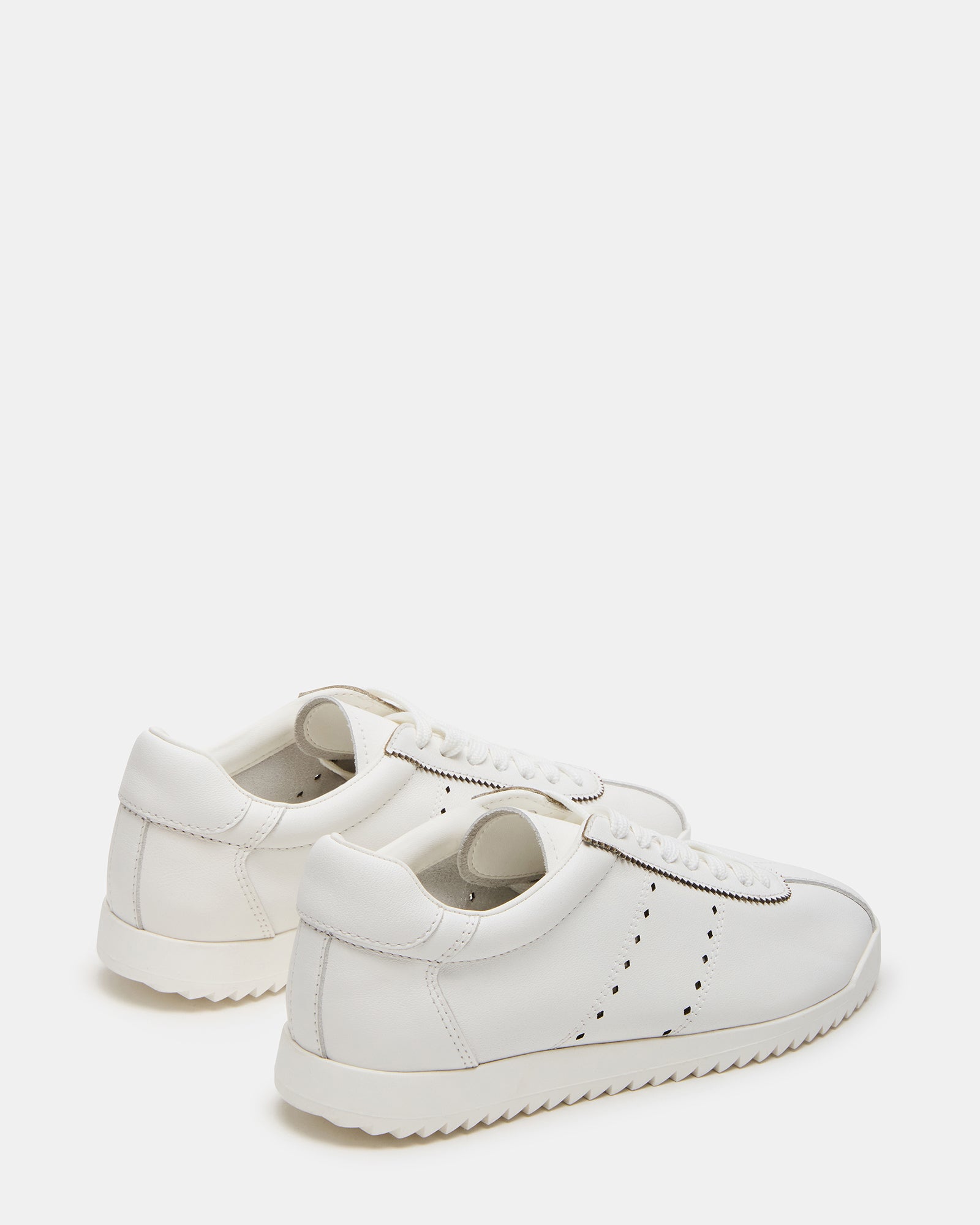 Mirage low-top sneakers in a casual outdoor setting.