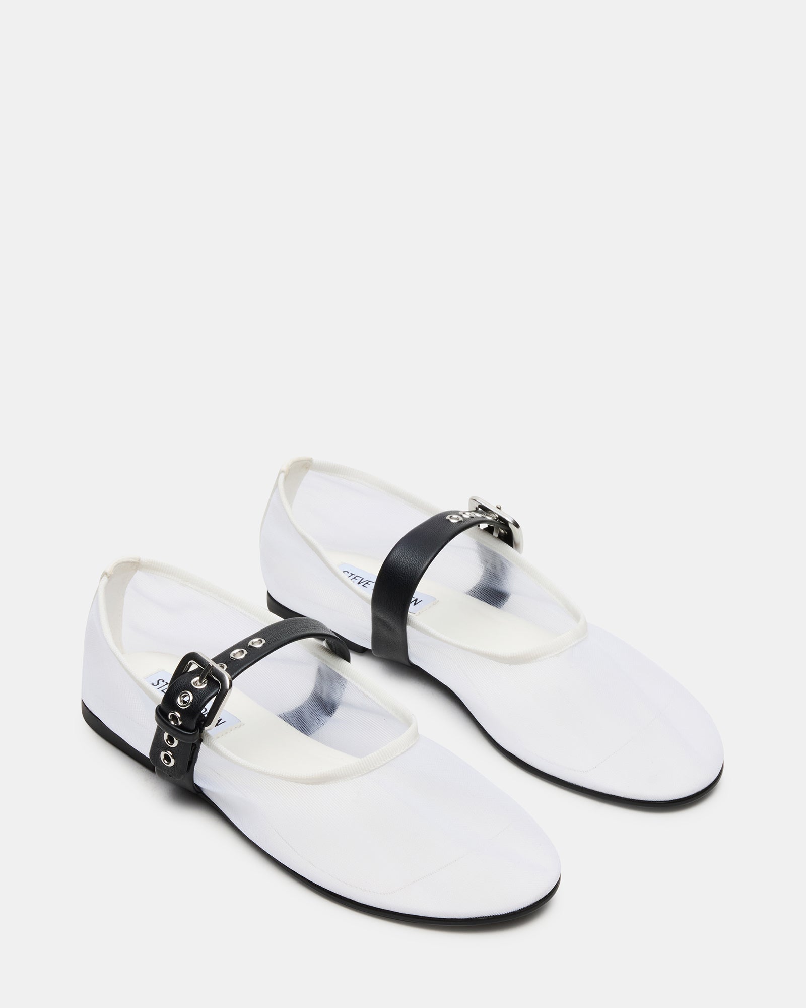 Top-down view of stylish flats in white/black with secure strap design.