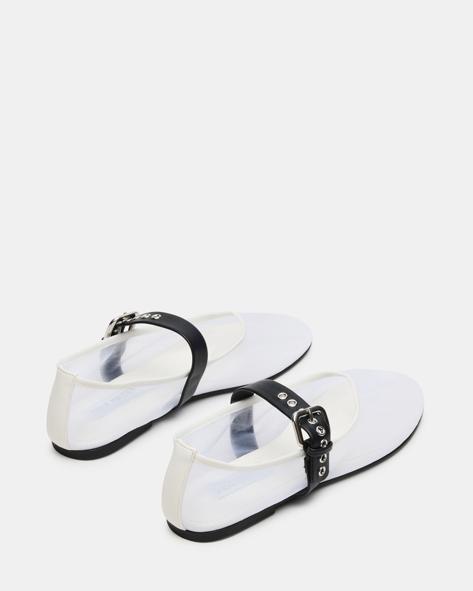 Top-down view of stylish flats in white/black with secure strap design.