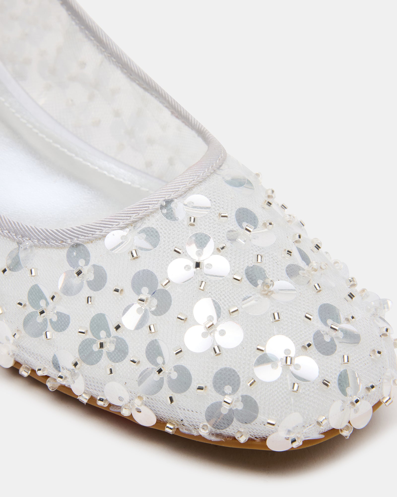 Model wearing silver sequin shoes at a festive event