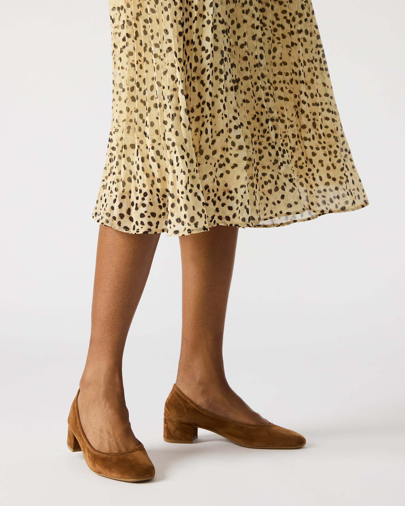 Model wearing Mollie Chestnut ballet shoes paired with chic outfit for evening wear