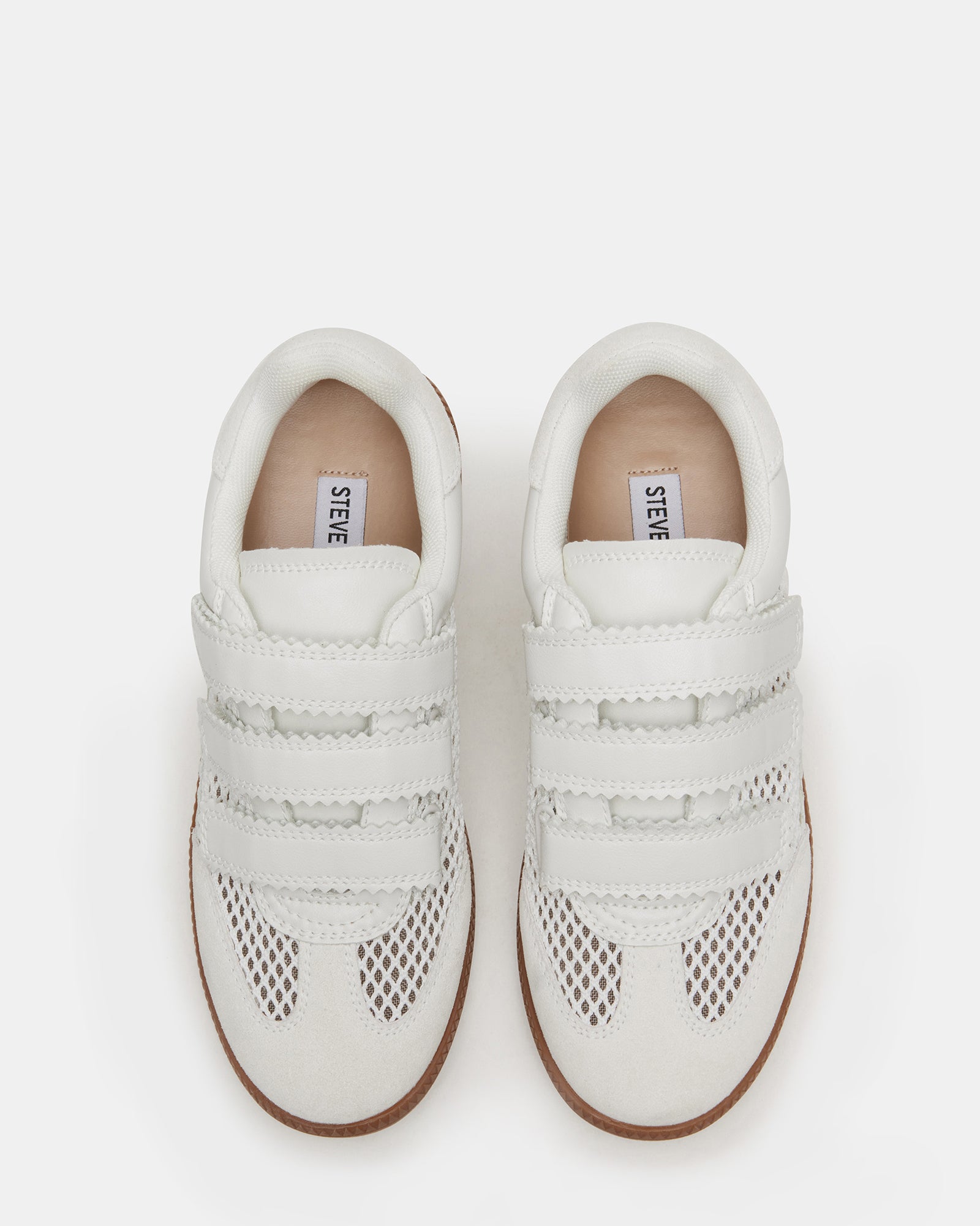 Side view of stylish white sneakers with Velcro closure for women