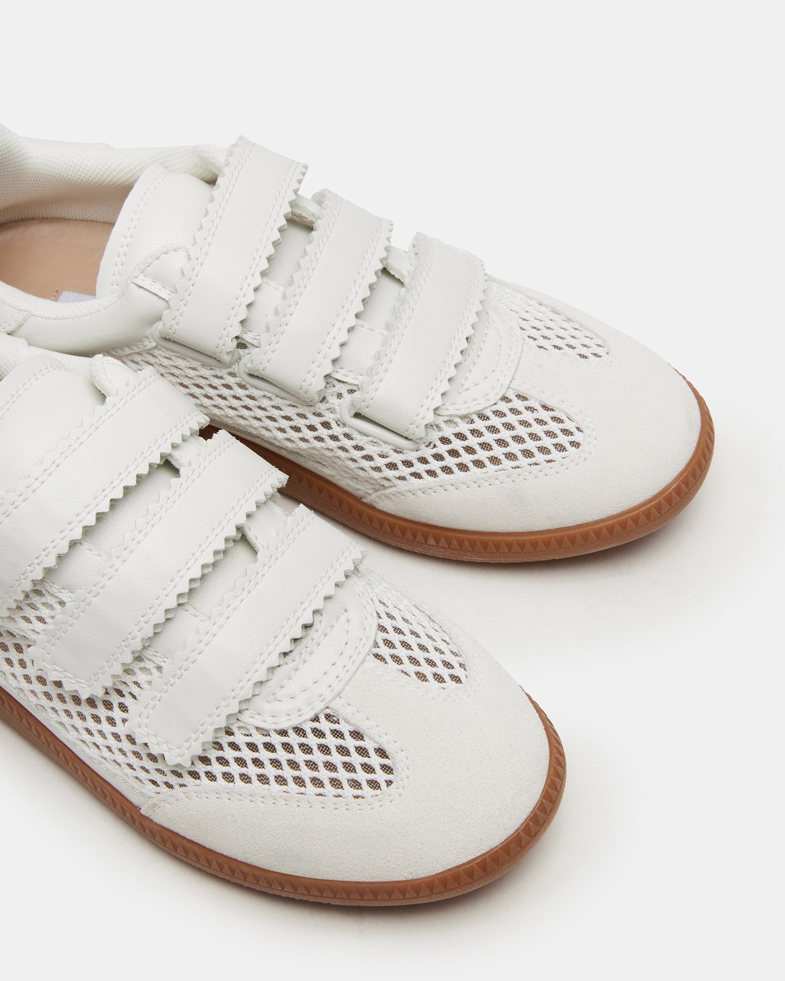 Women wearing comfortable white sneakers with Velcro for casual outings