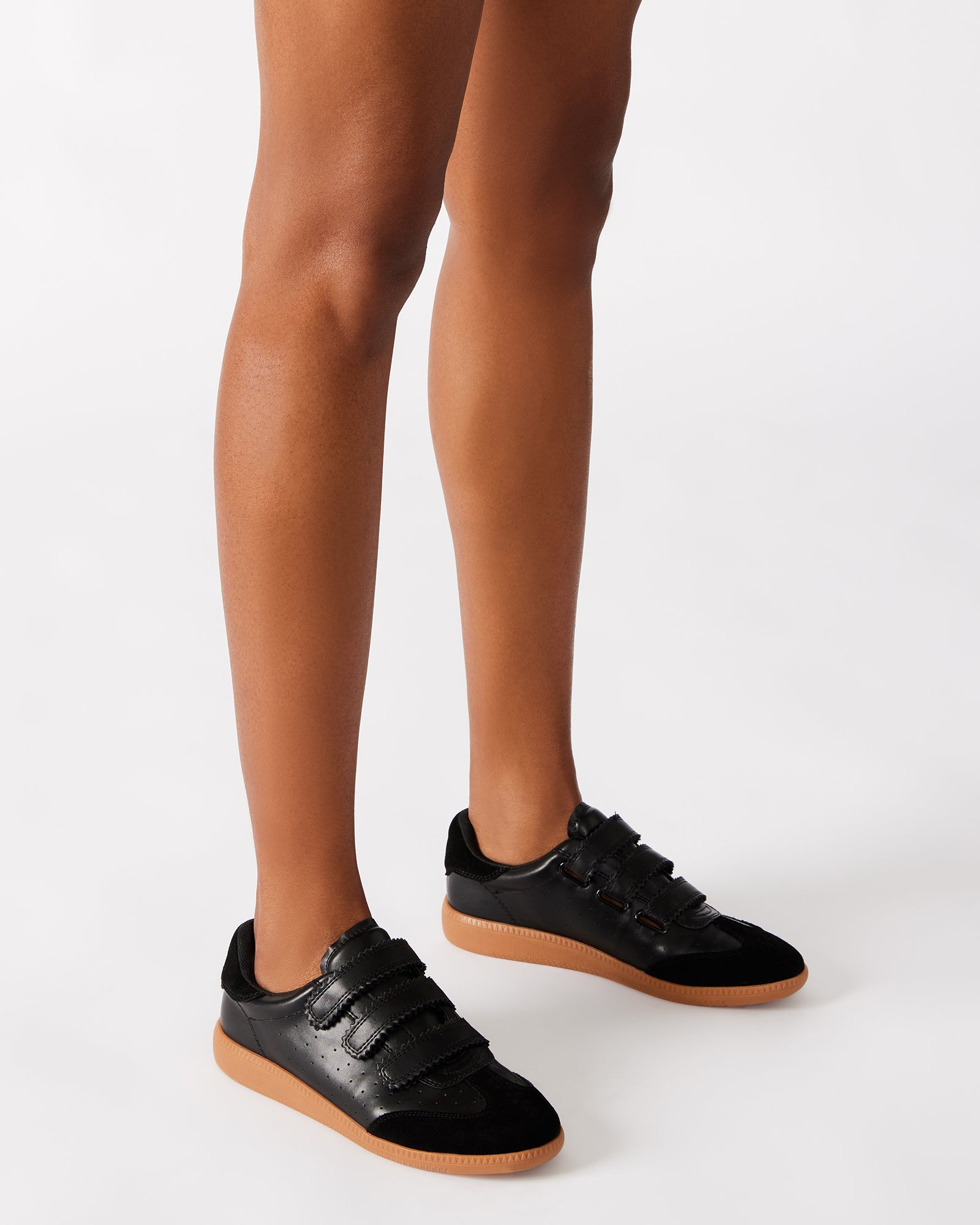 Front angle of the sneakers highlighting the suede and synthetic upper.