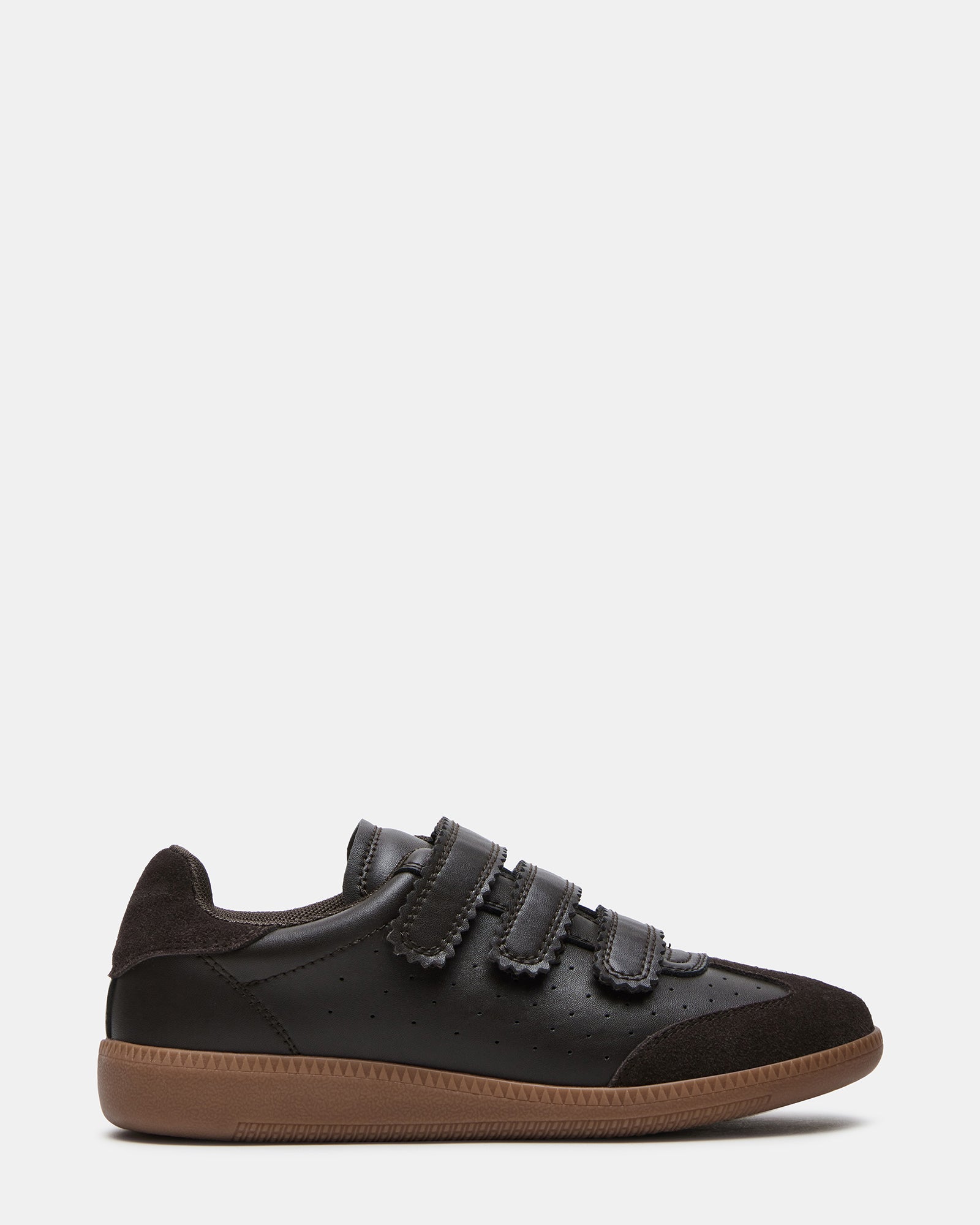 Close-up of brown suede sneakers showing Velcro strap detail