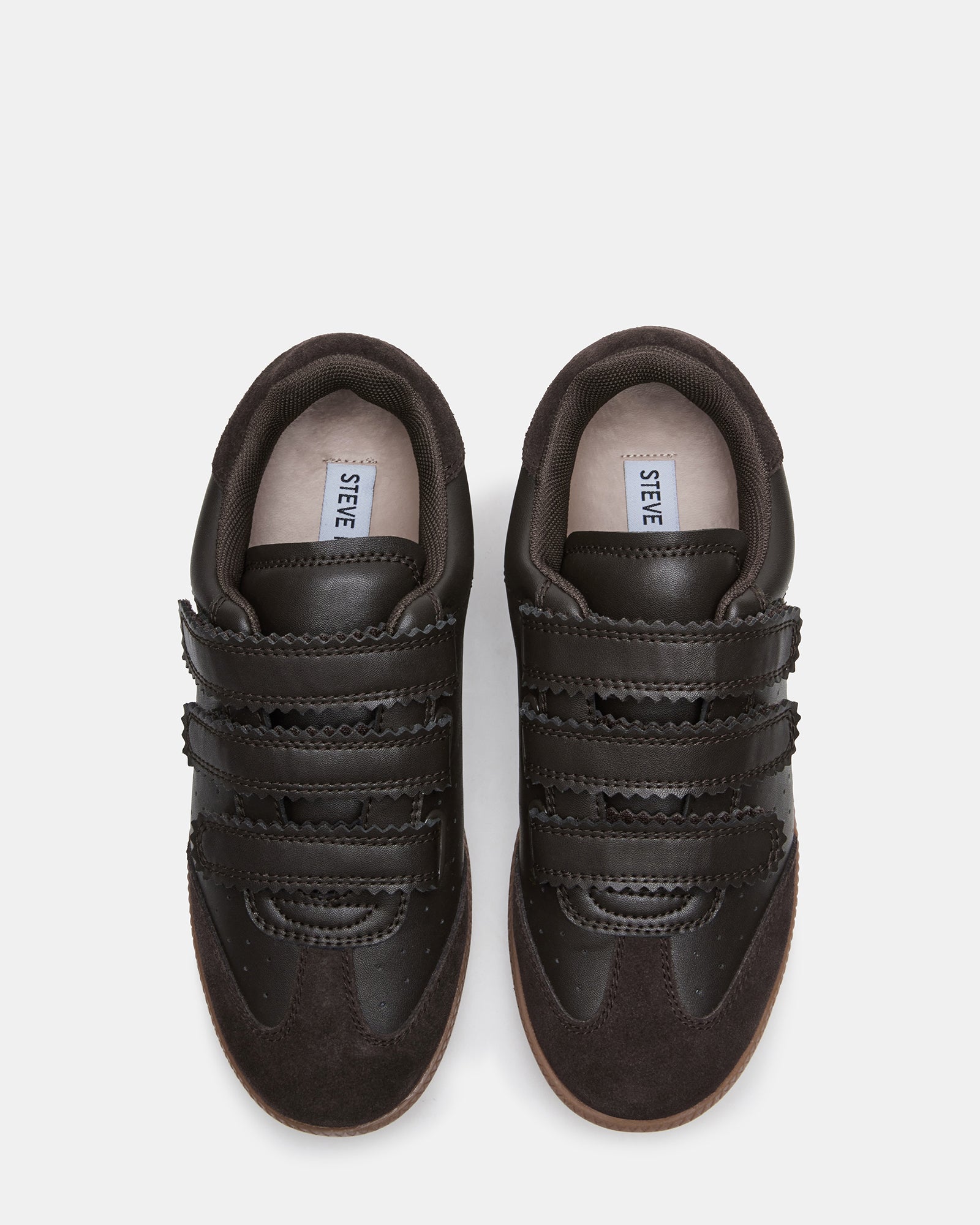 Side view of Momentum sneakers on a city street