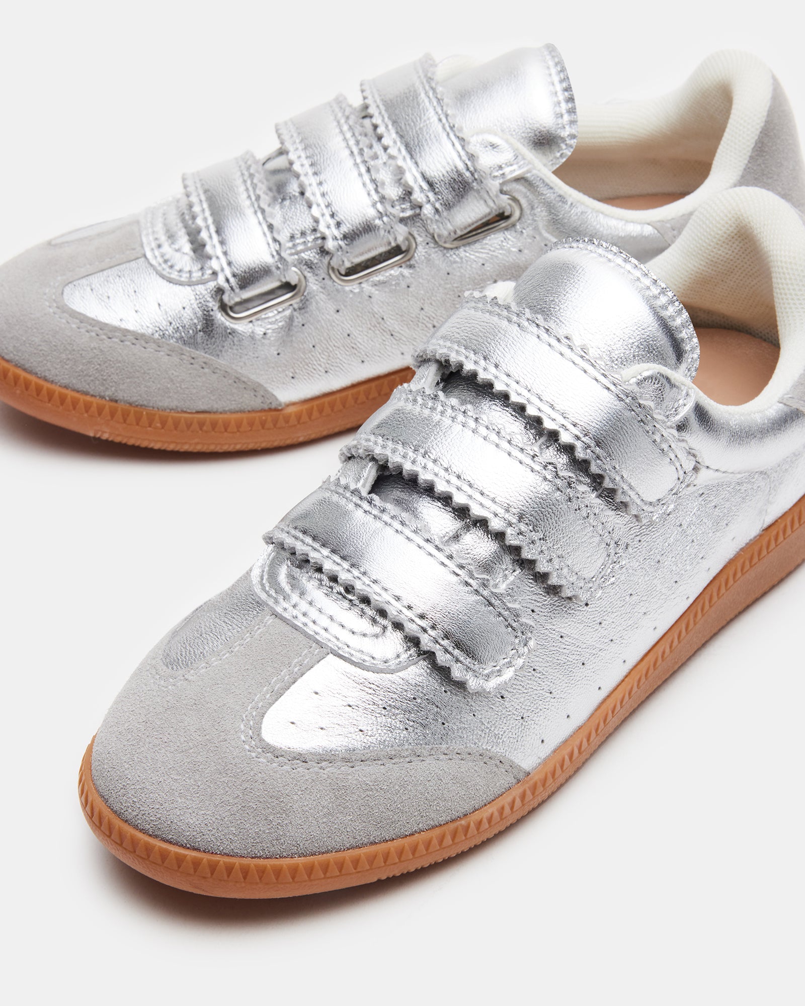 Side view of black leather sneakers with suede trim and velcro strap