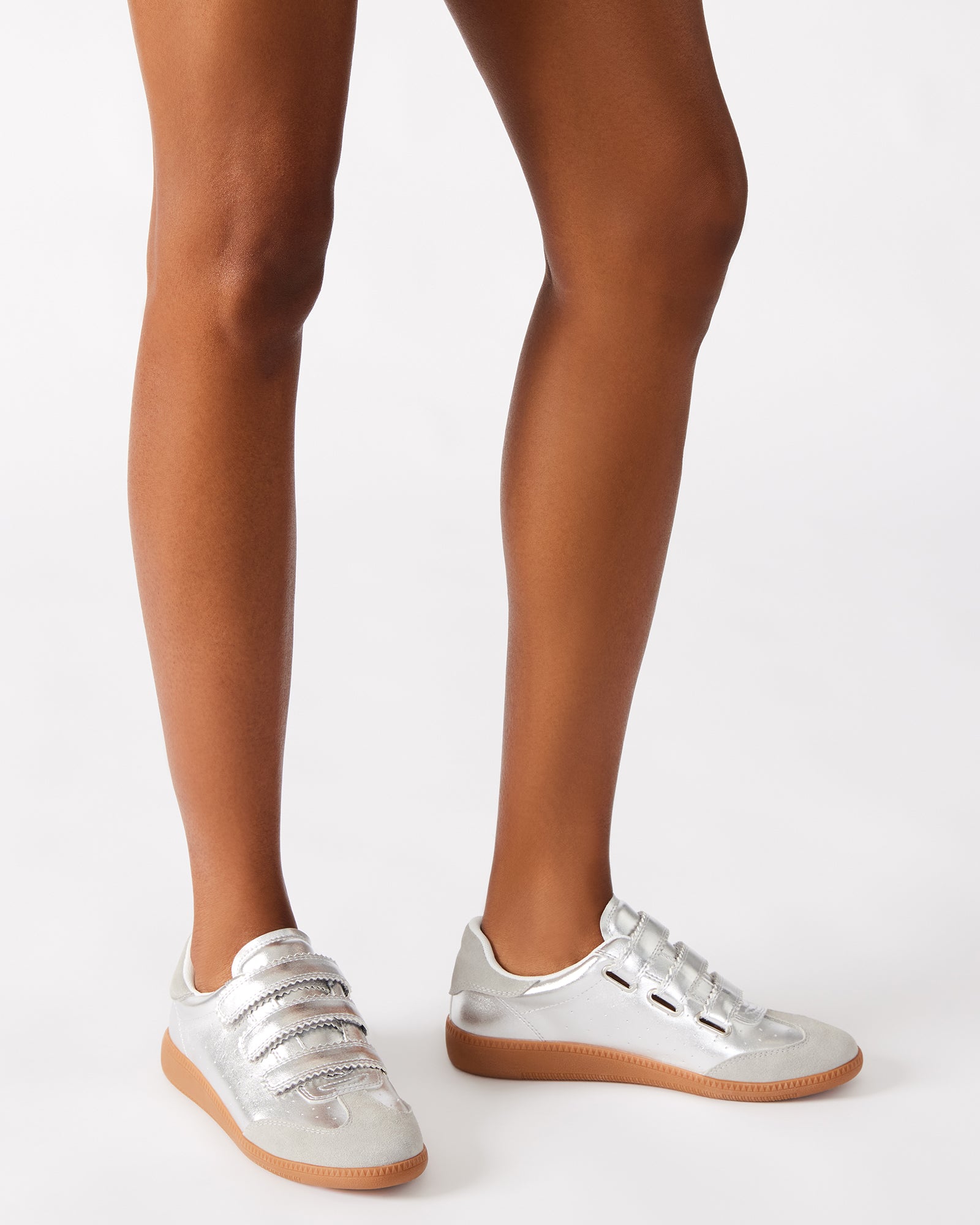 Overhead close-up of velcro sneakers showing sleek silhouette and stitching details