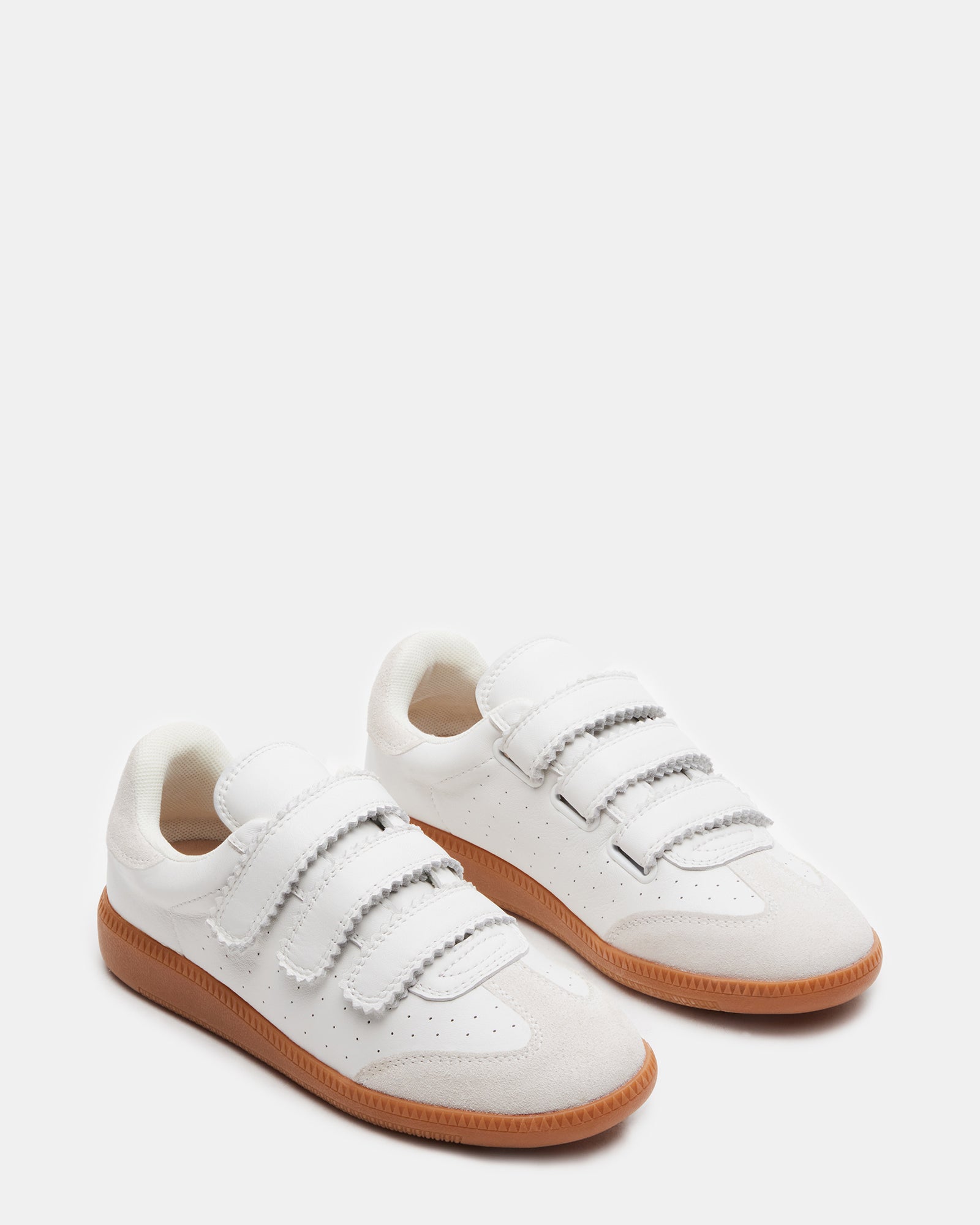 Momentum White Velcro sneakers worn casually in a park, perfect for everyday comfort.