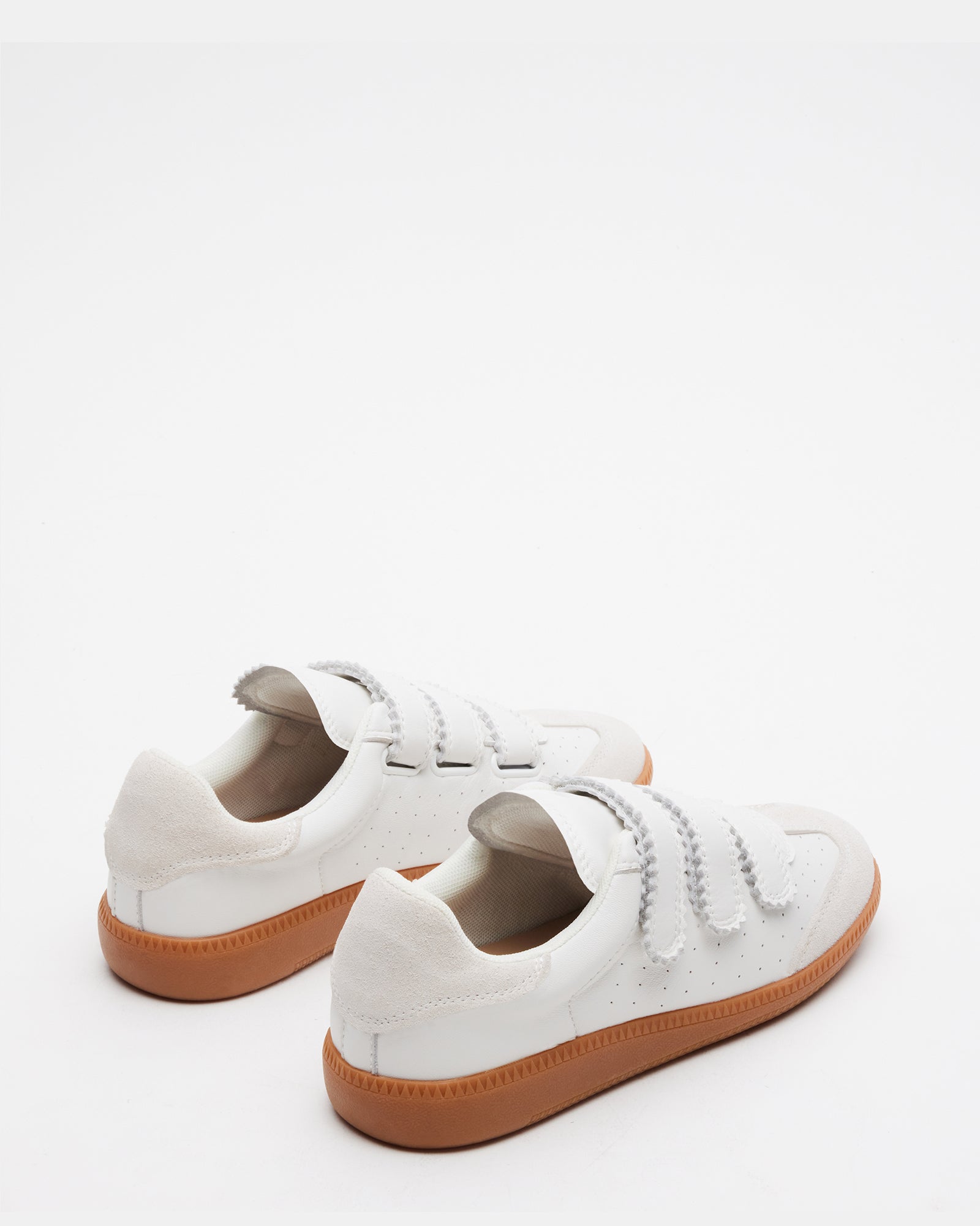 Momentum White Velcro sneakers worn casually in a park, perfect for everyday comfort.