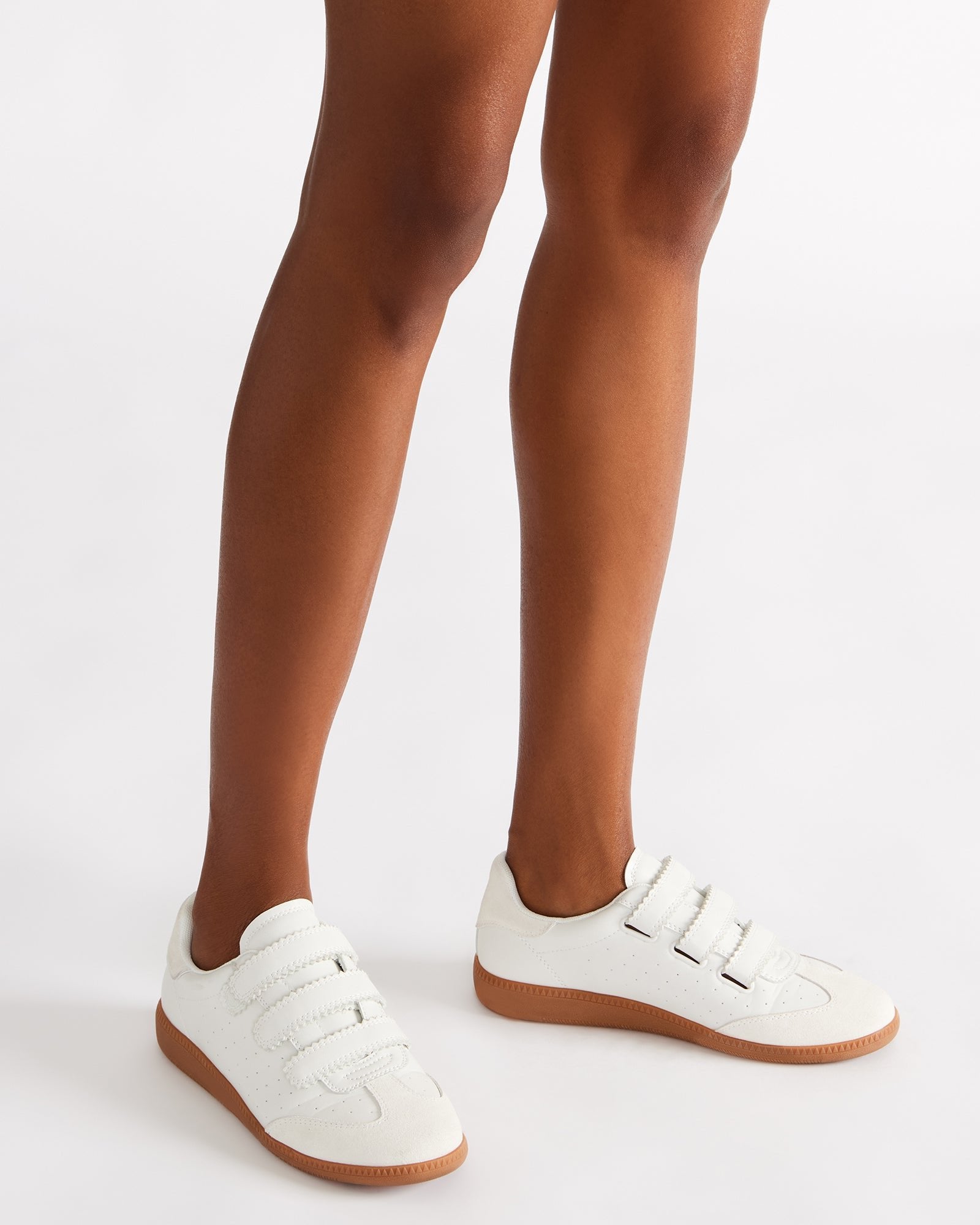 Women wearing comfortable white sneakers with Velcro for casual outings