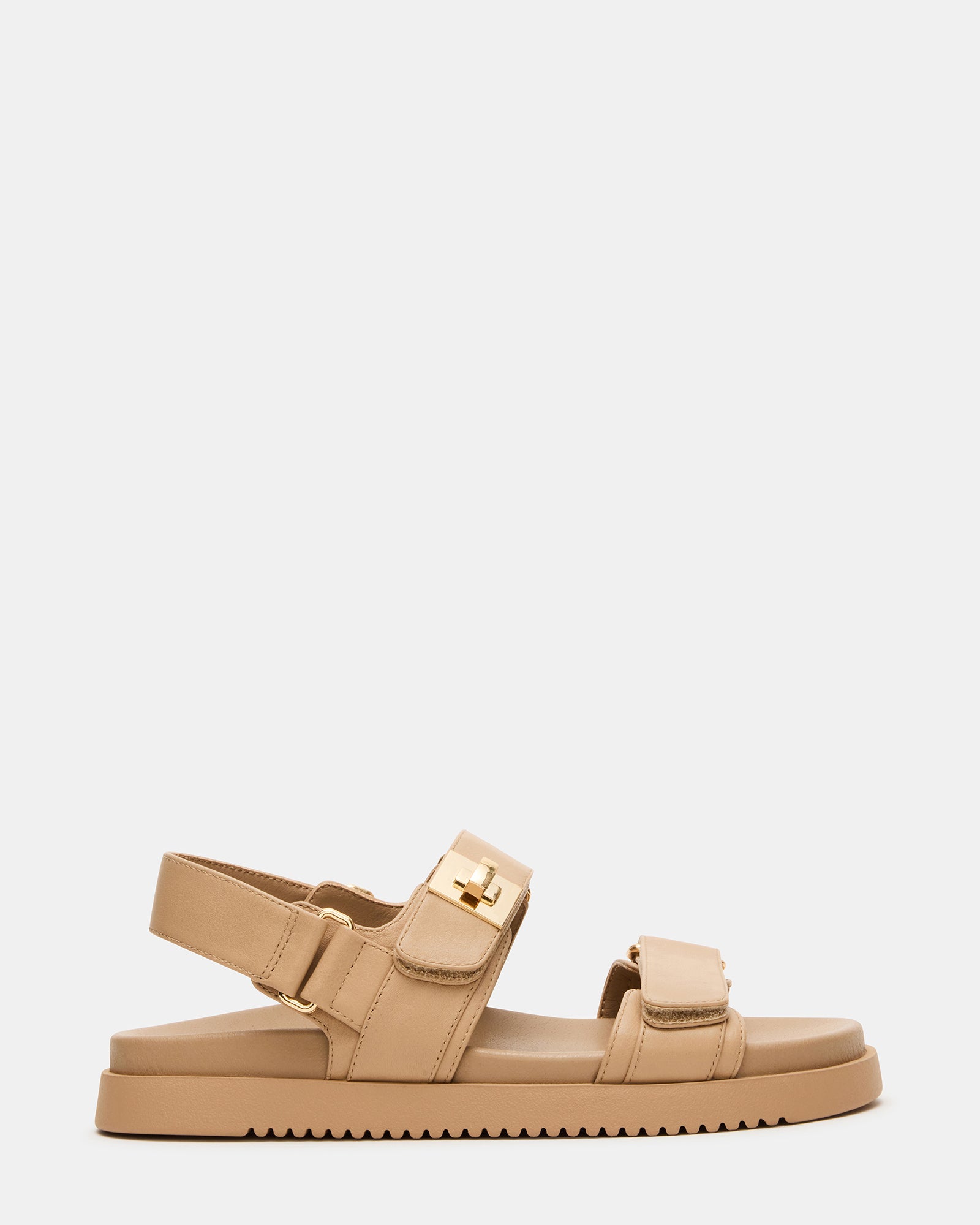 MONA beige leather sandals on a wooden deck, showcasing the flatform sole and adjustable straps.