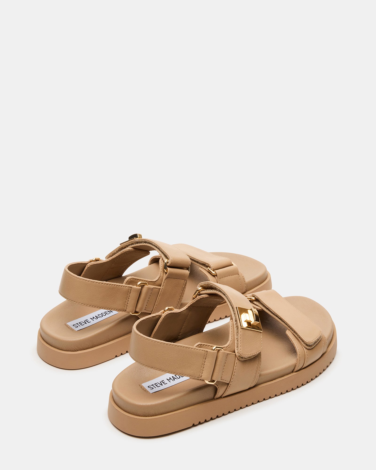 Woman wearing these brown leather sandals with a casual summer outfit.