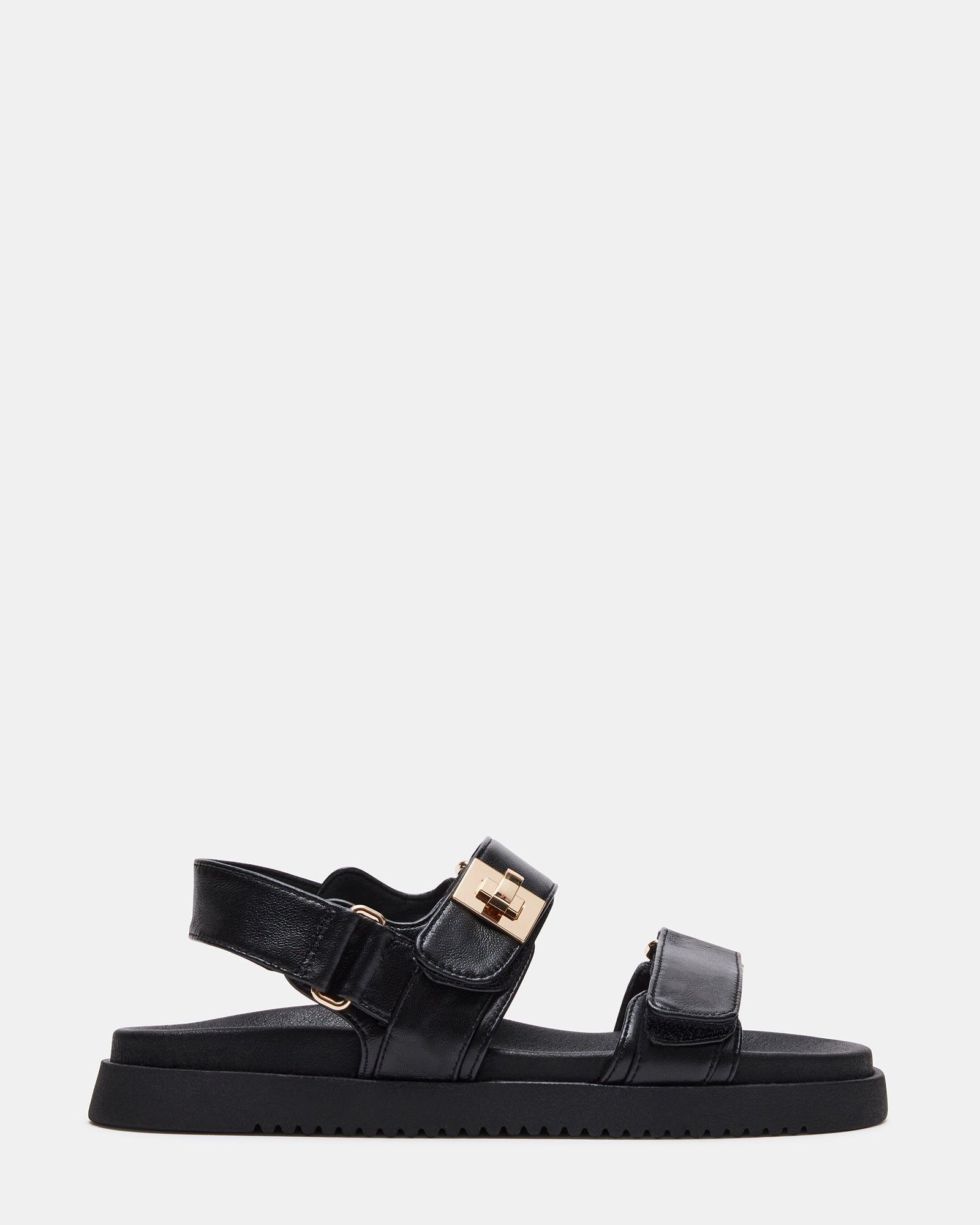 Top view of black flat sandals with molded footbed and gold hardware