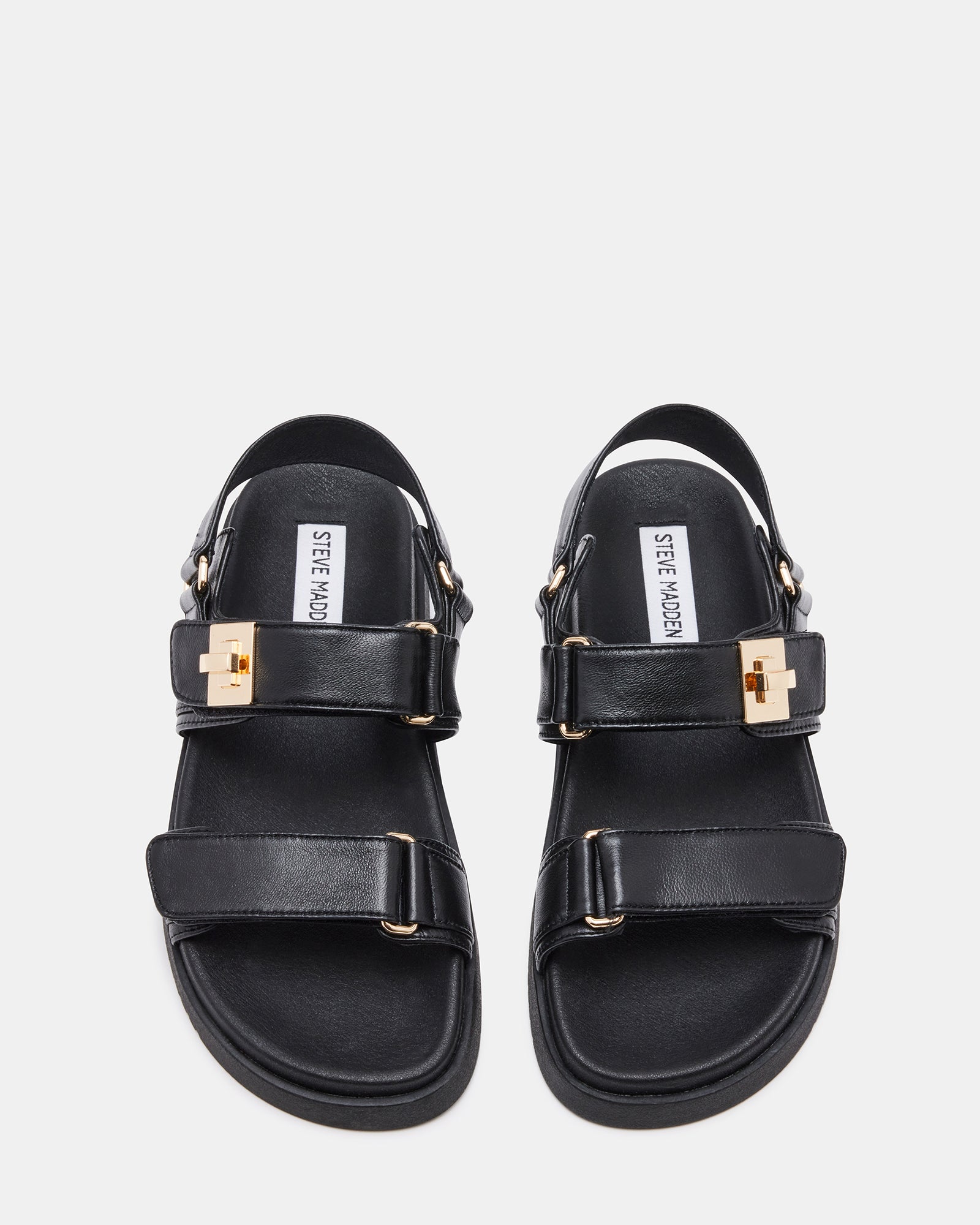 Side angle of black platform sandals styled with casual jeans