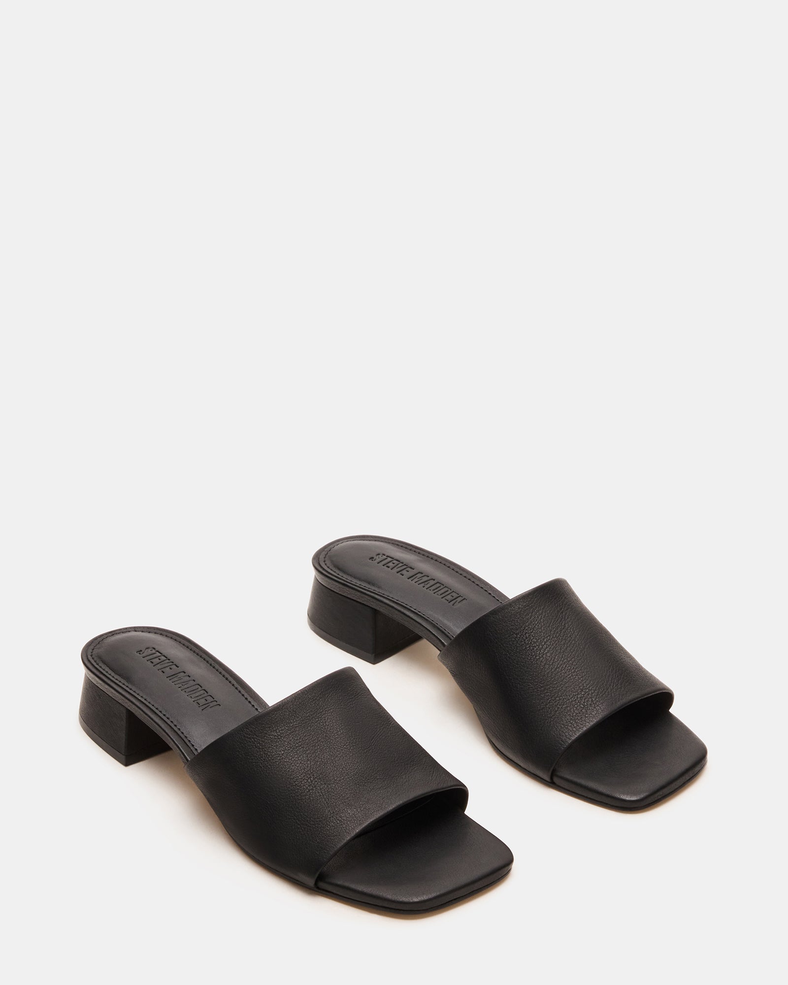 Pair of mens leather sandals styled with rolled jeans