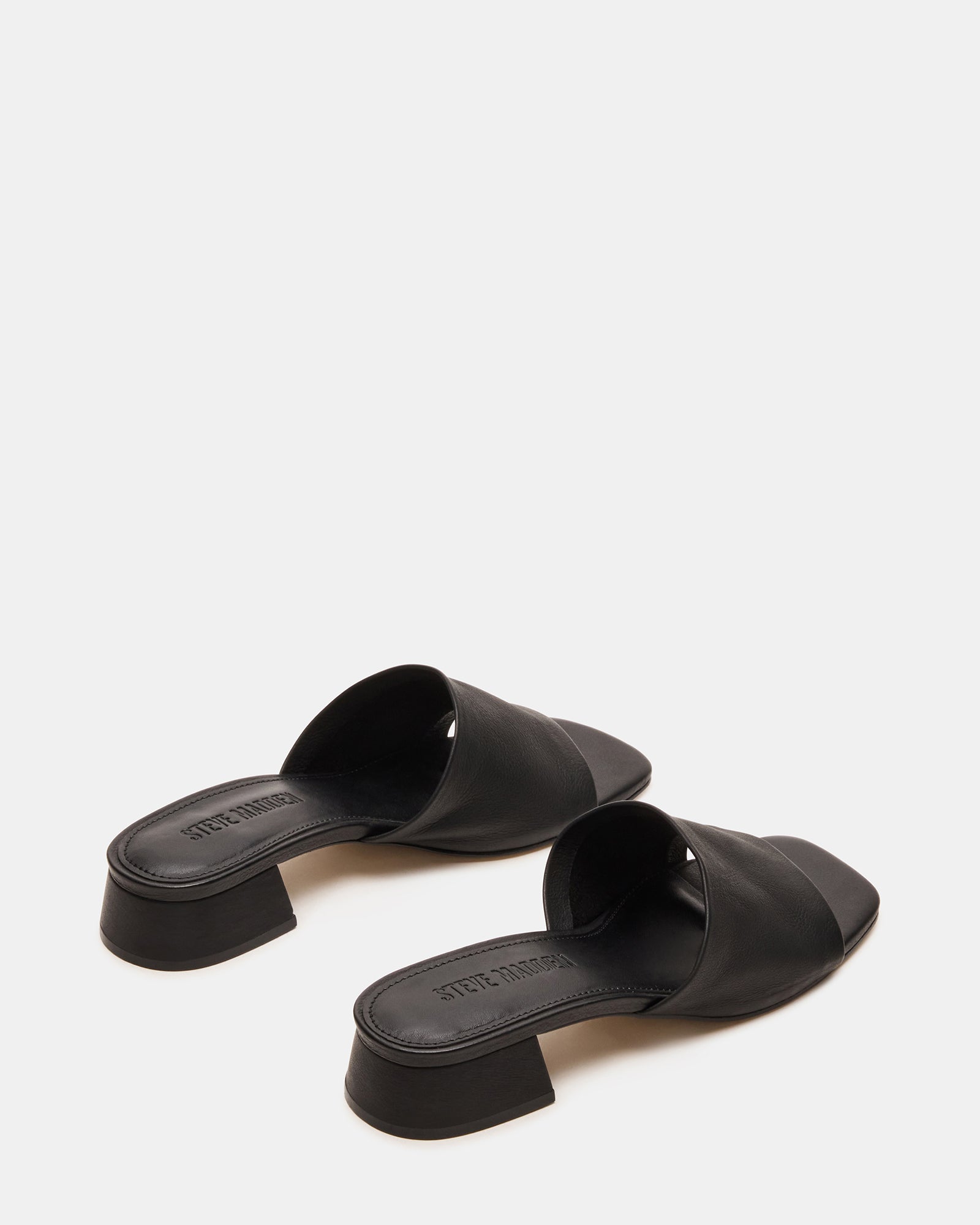 Pair of mens leather sandals styled with rolled jeans