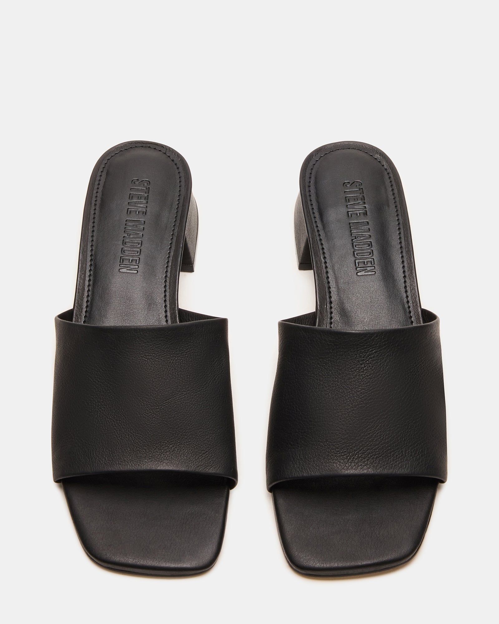 Close-up of square toe design on brown leather sandals