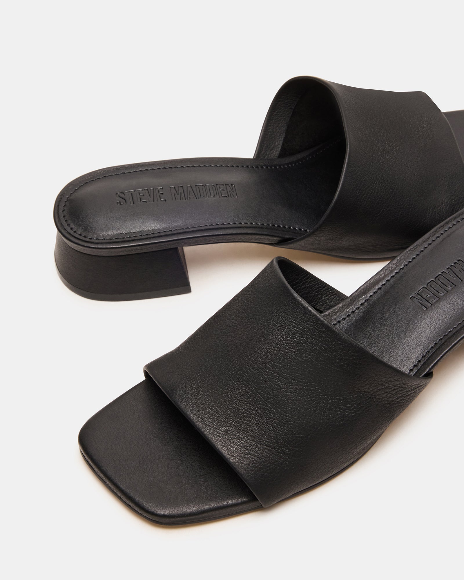 Side view of Montgomery leather sandals for women on cobblestone