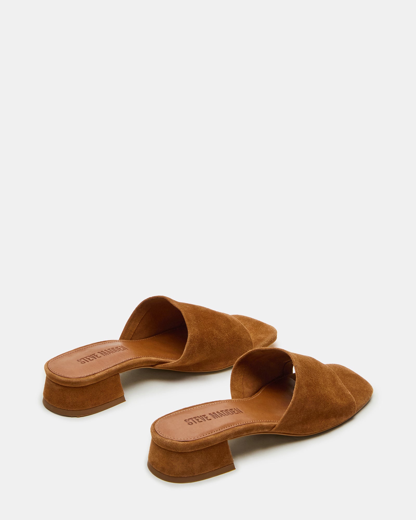 Woman wearing suede platform slides outdoors in warm weather
