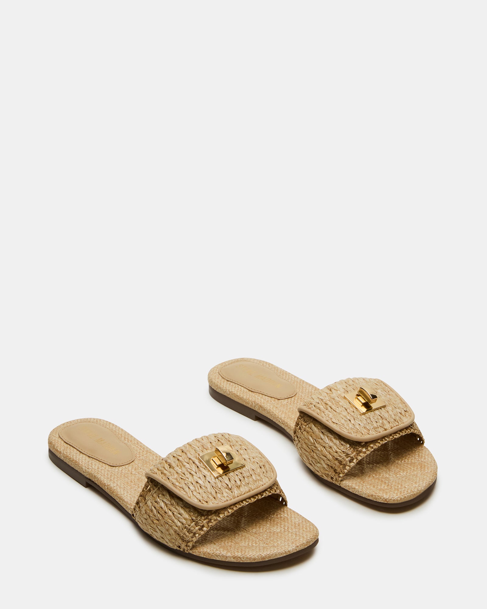 Side view of slide sandals highlighting the textured raffia upper and heel cushioning.