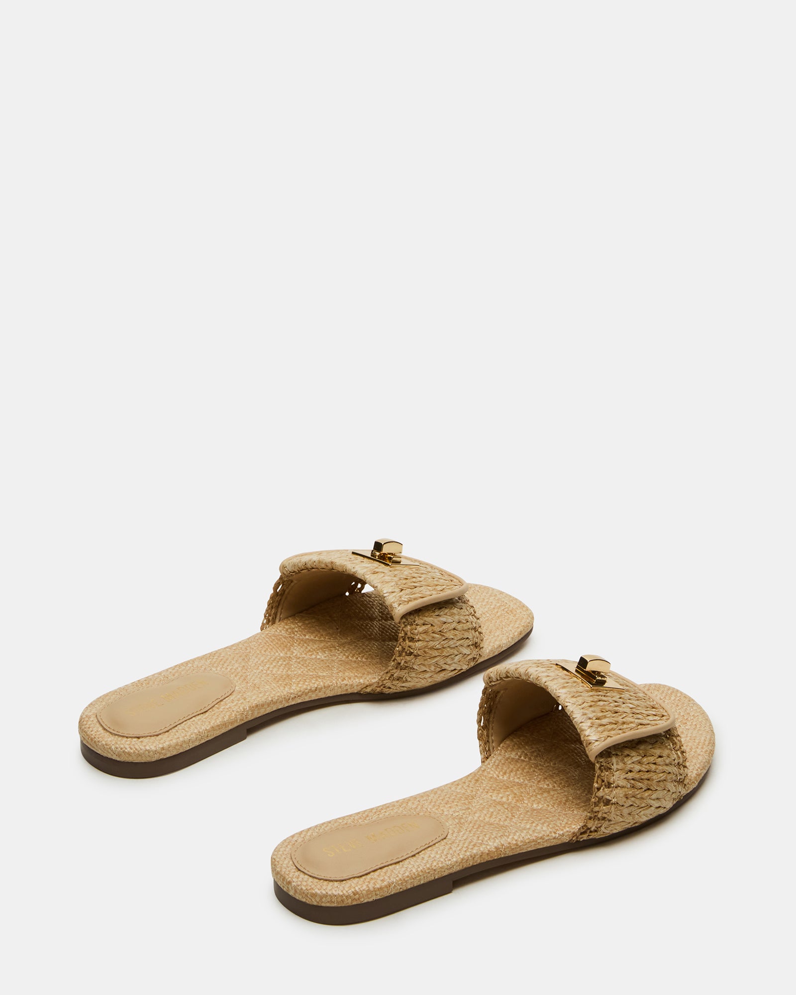 Side view of slide sandals highlighting the textured raffia upper and heel cushioning.