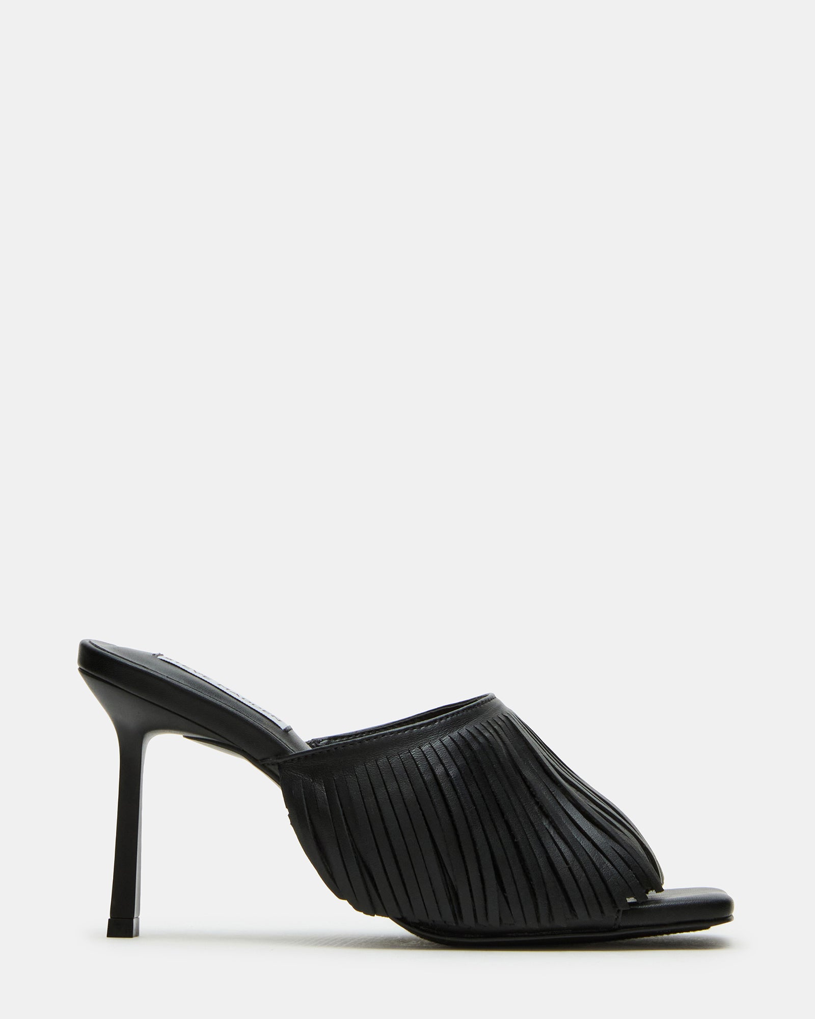 Side view of black strappy heels showcasing the fringe detail and square toe.