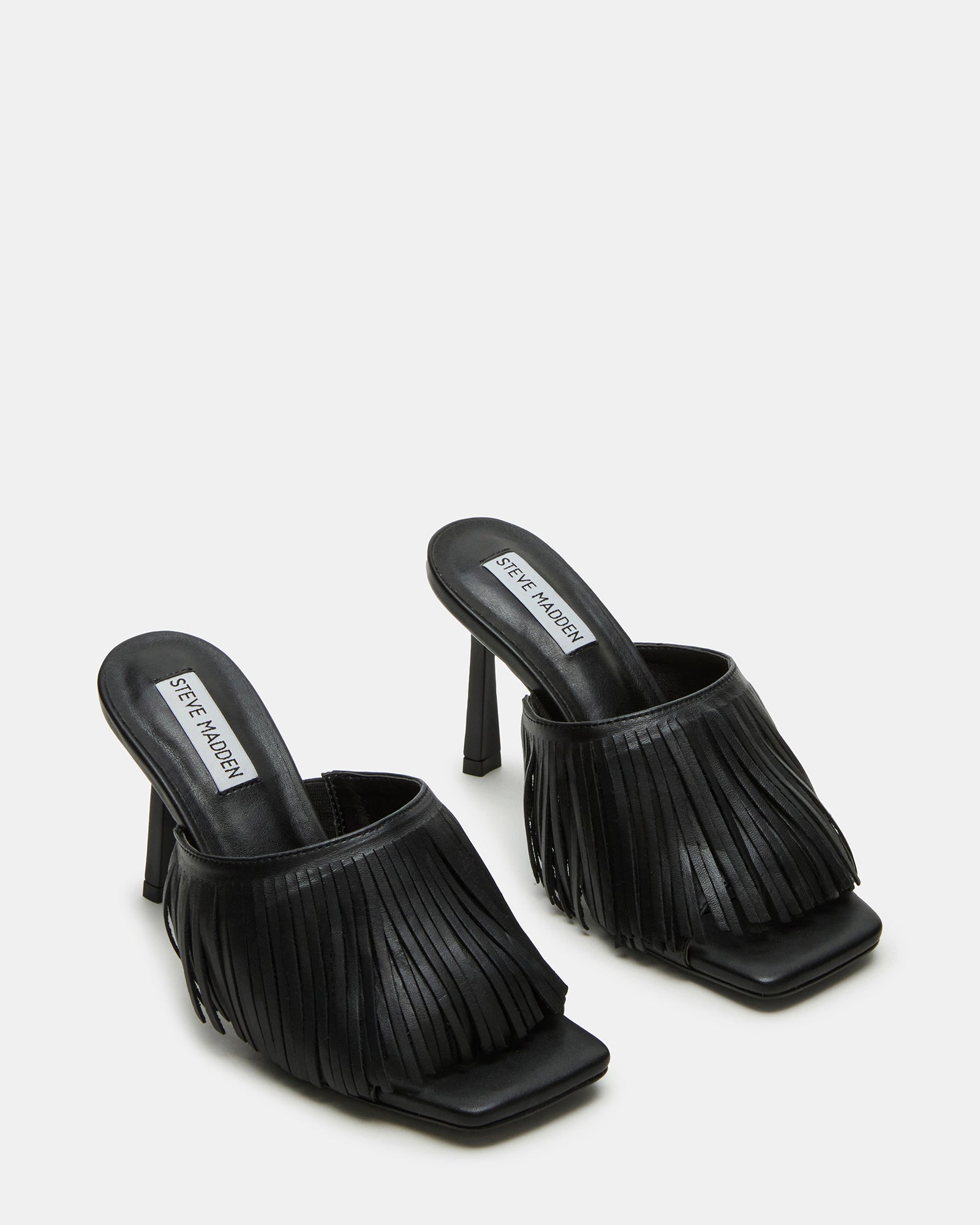 Close-up of black kitten heels highlighting the leather texture and stiletto heel.