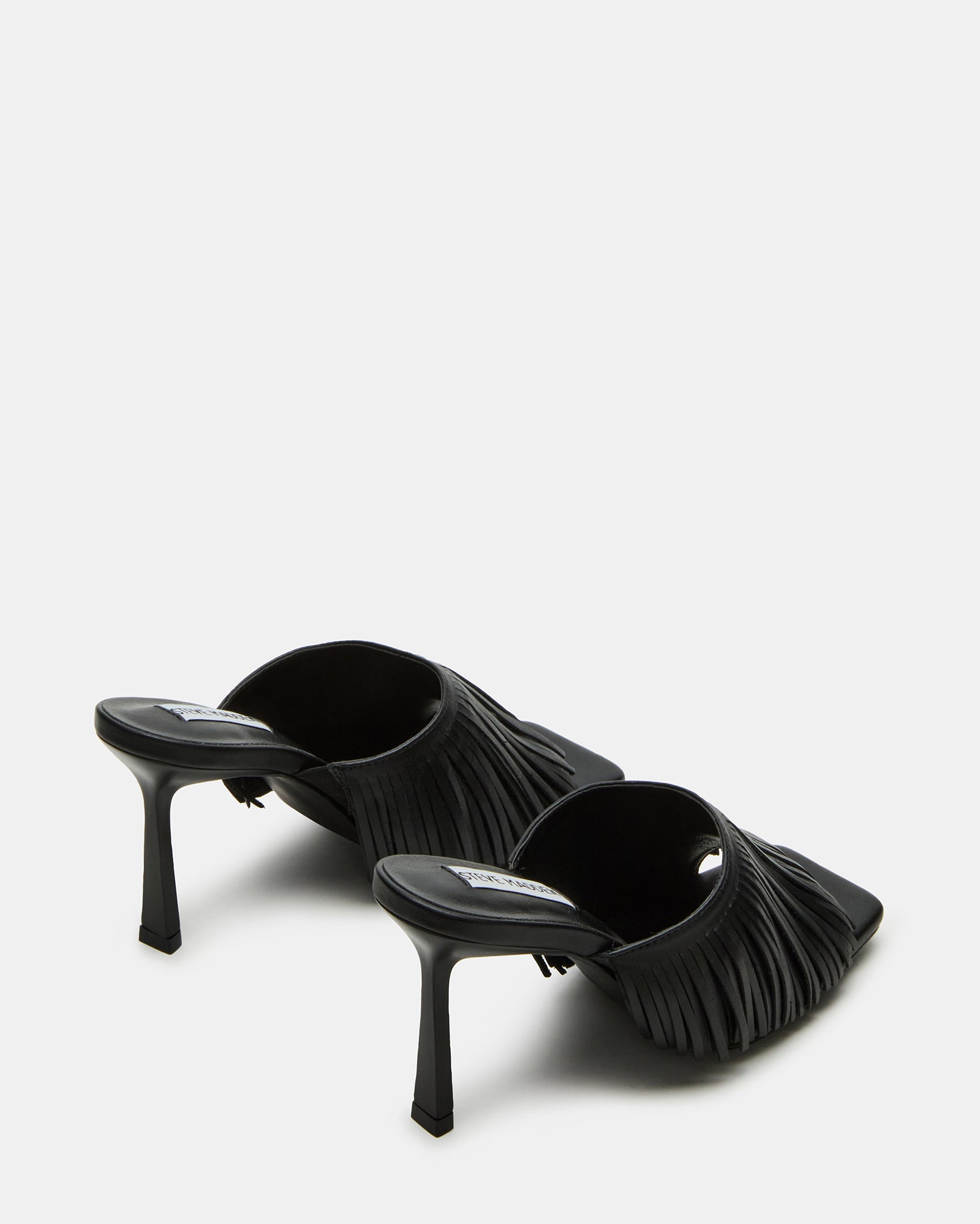 Close-up of black kitten heels highlighting the leather texture and stiletto heel.