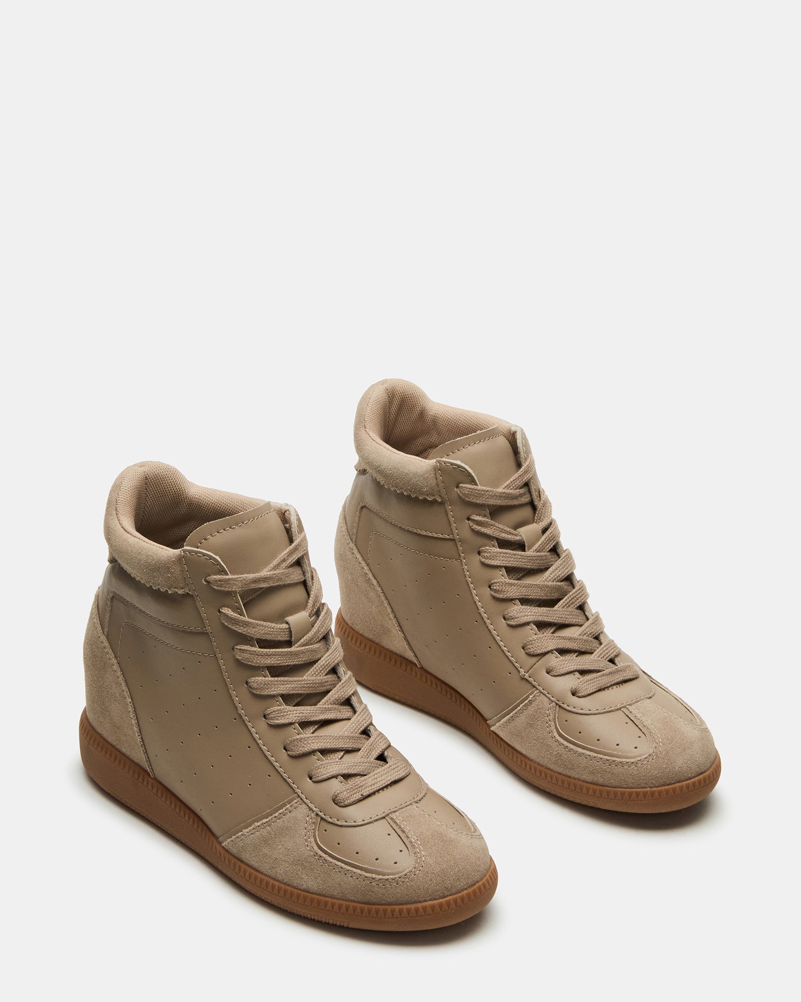 Top-down view of womens black wedge sneakers styled for an urban weekend look