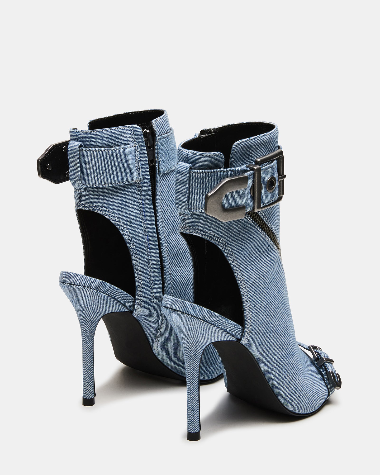 Close-up of black stiletto heels on a model walking confidently.