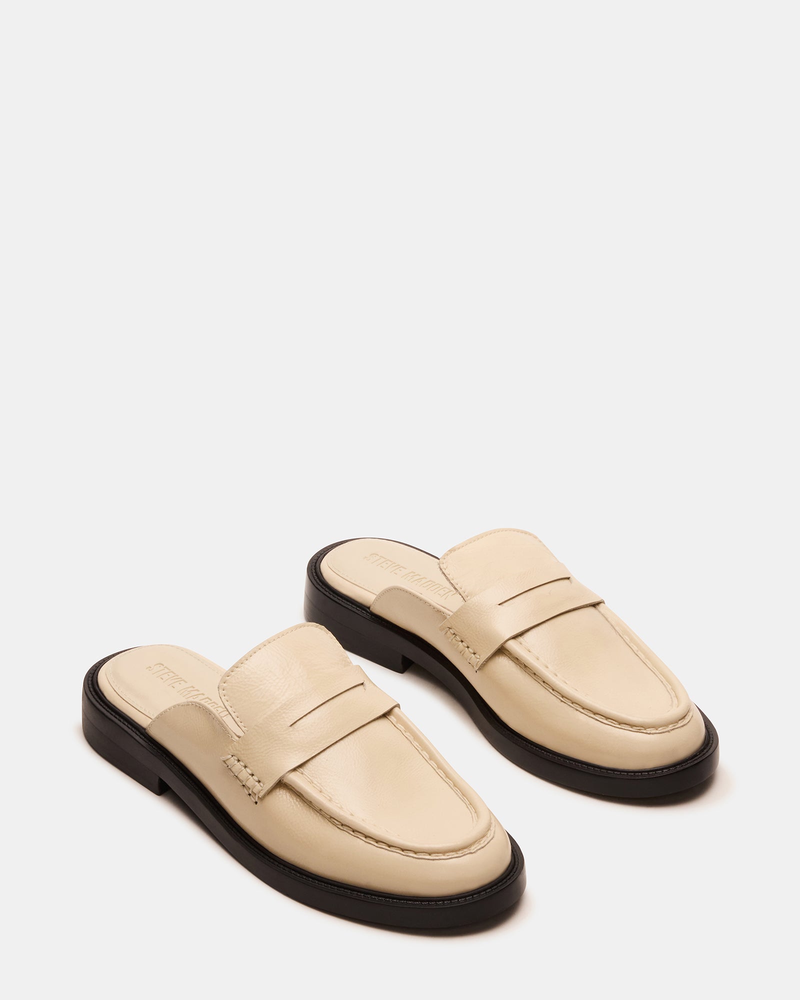 Side view of Mulberry leather flats highlighting the sleek mule design.