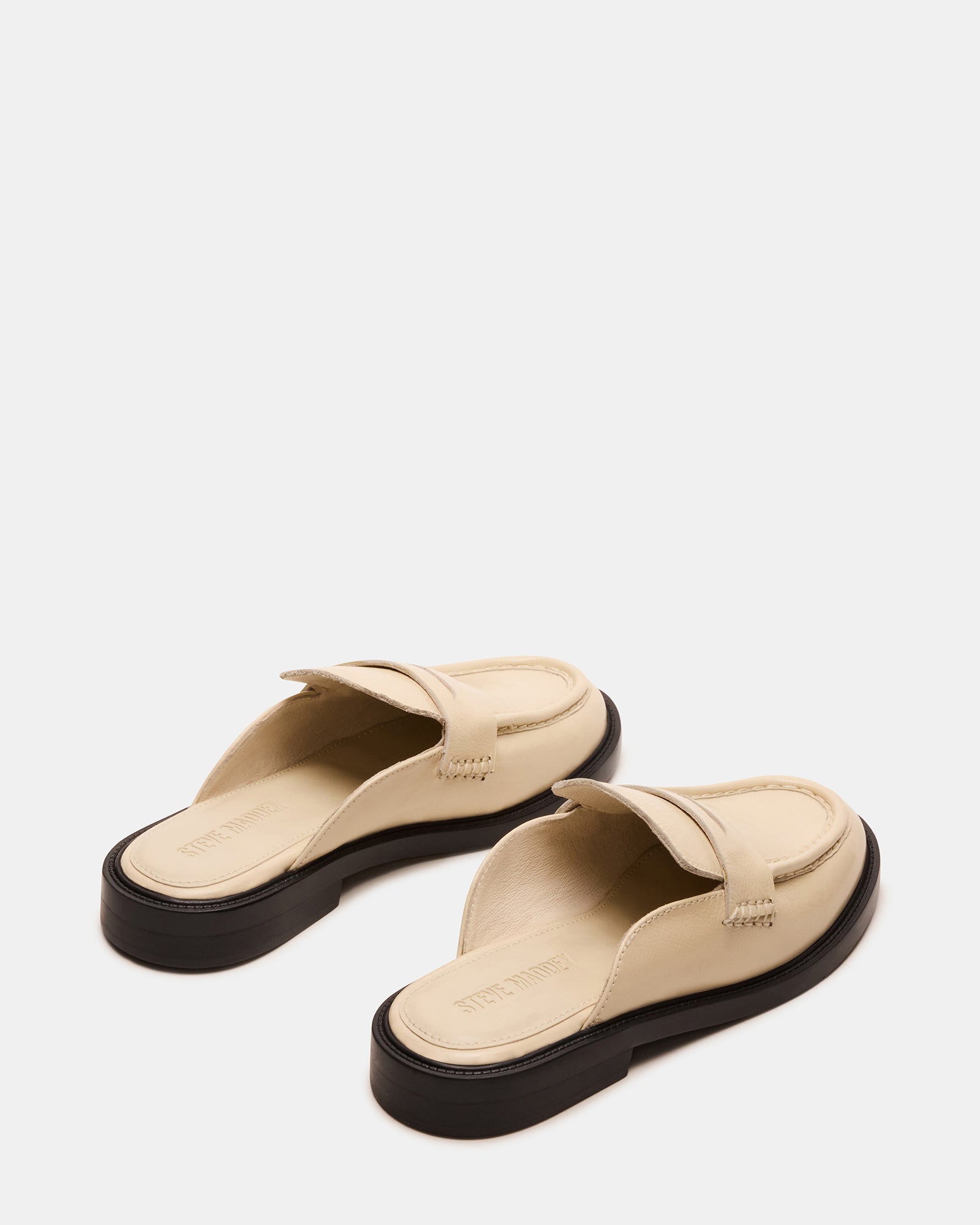Side view of Mulberry leather flats highlighting the sleek mule design.
