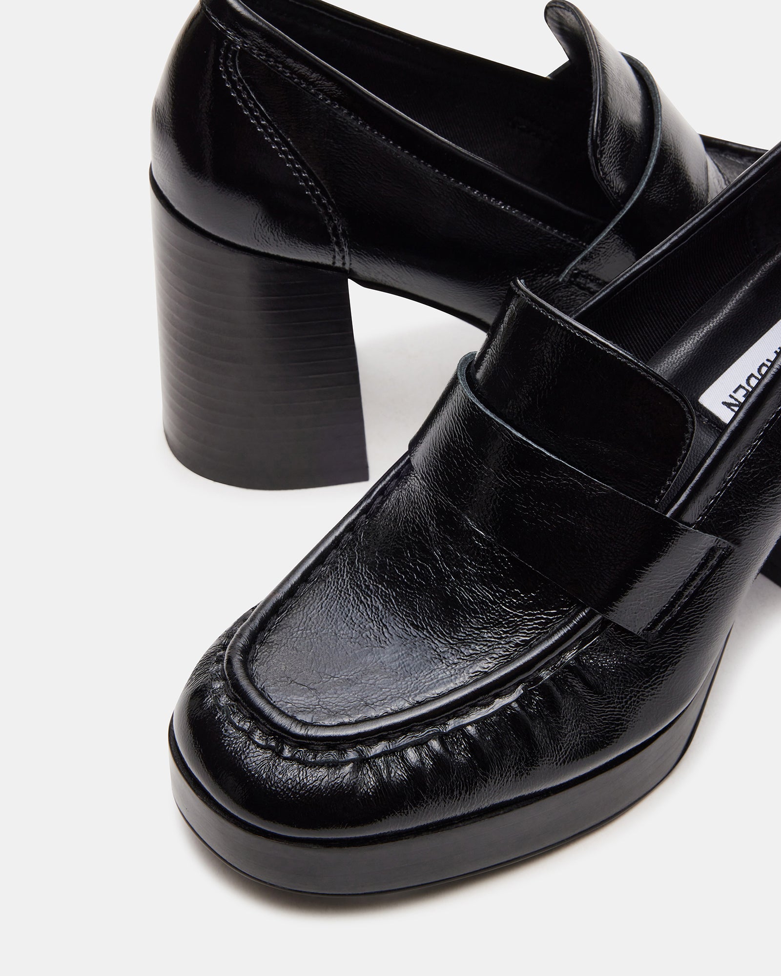 Side view of black leather loafer with platform heel for casual wear