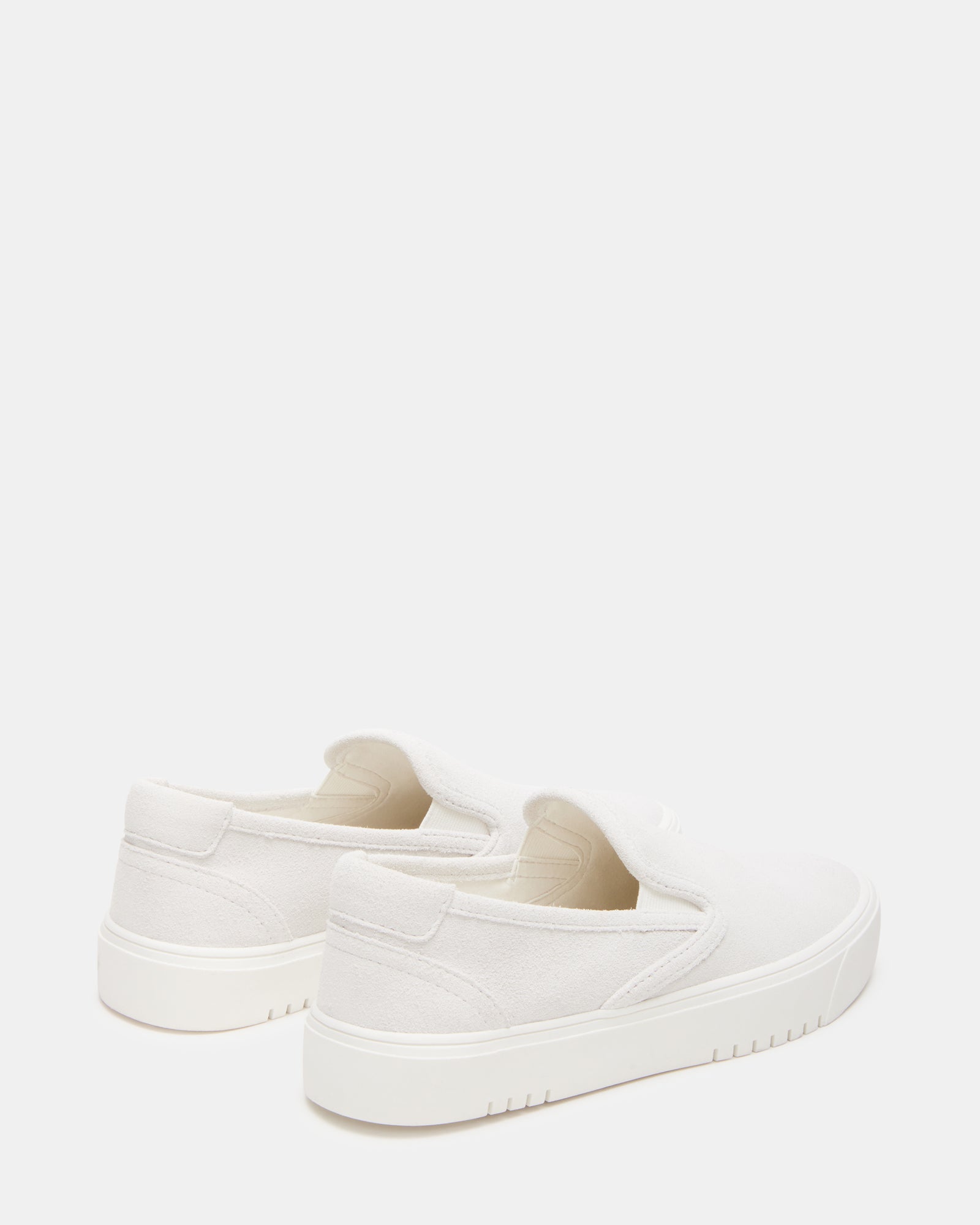 Close-up of rounded toe and heel design on white suede shoes