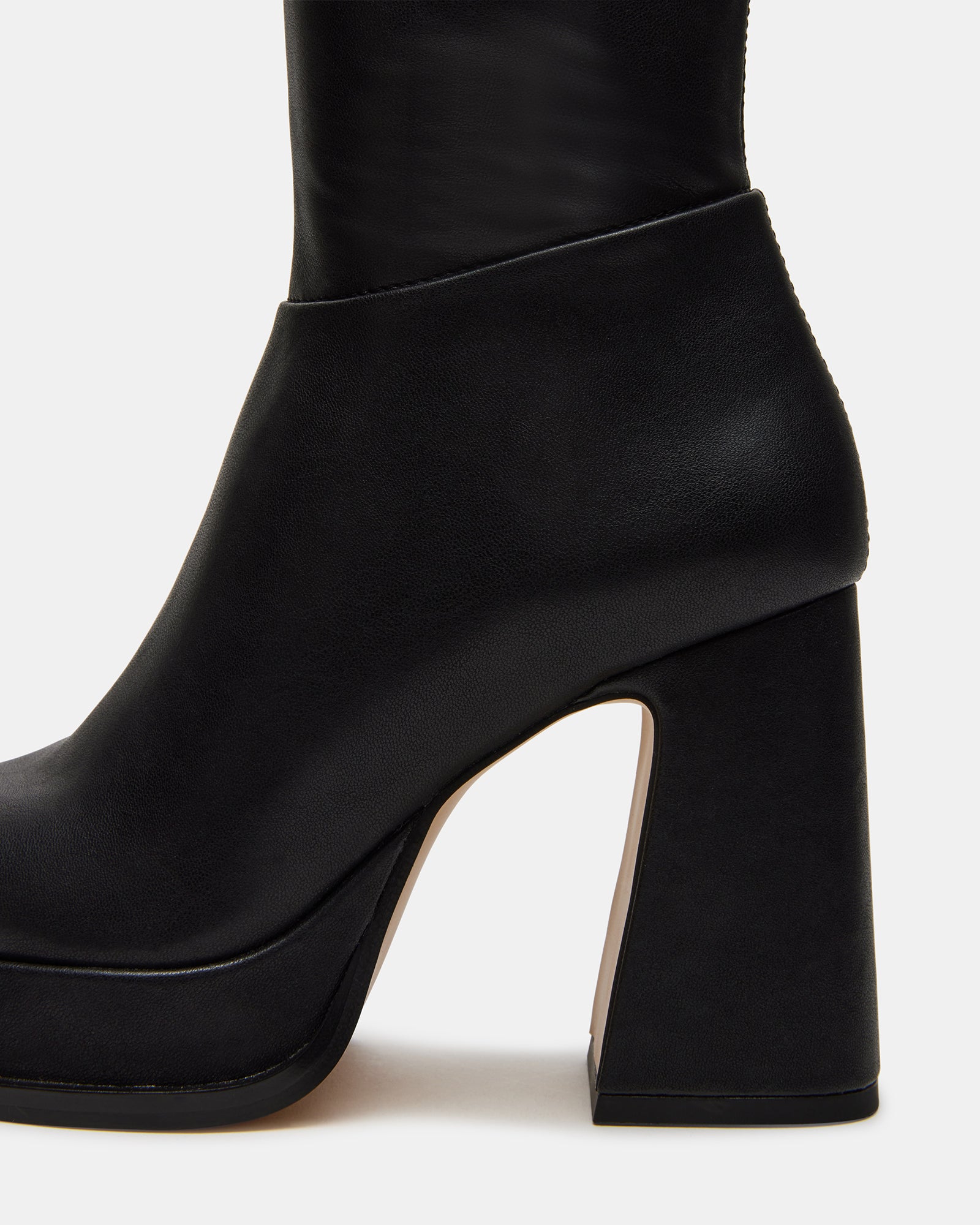 Myndie Black knee-high platform boots styled with a casual outfit.