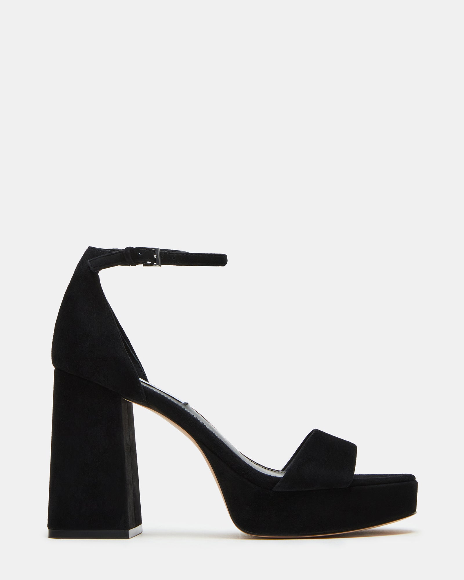 Black suede platform heels with ankle strap on a model's feet for a night out