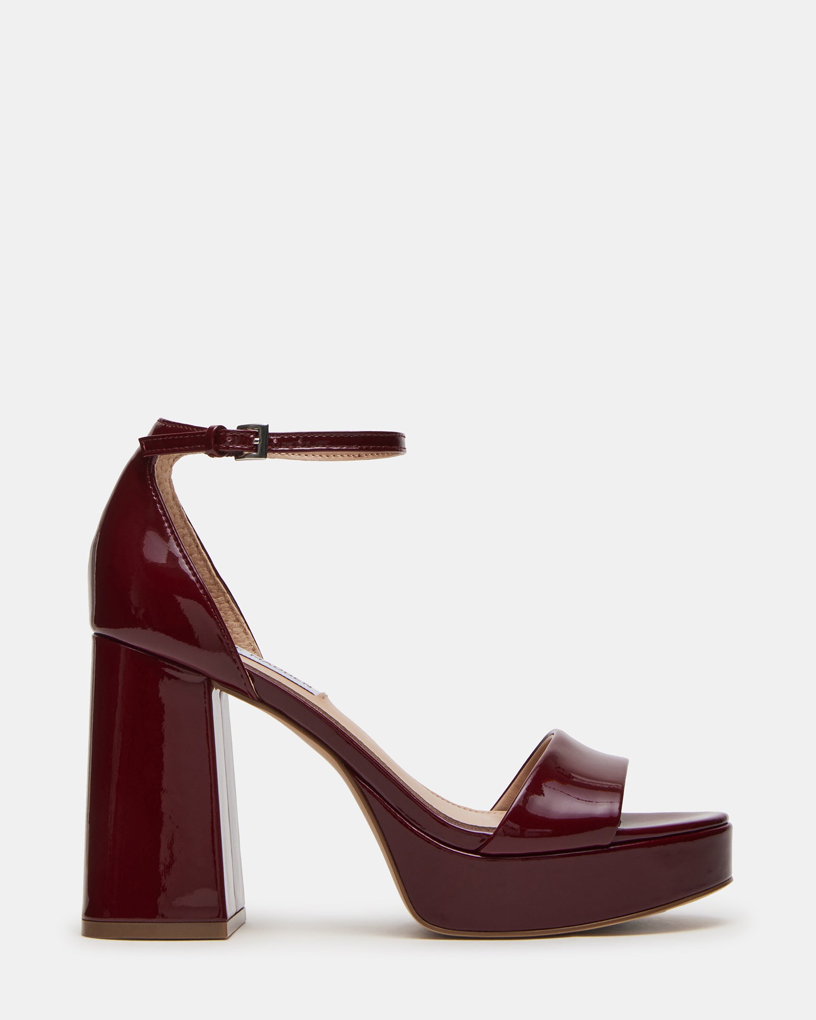 Side view of burgundy block platform heels styled with evening wear