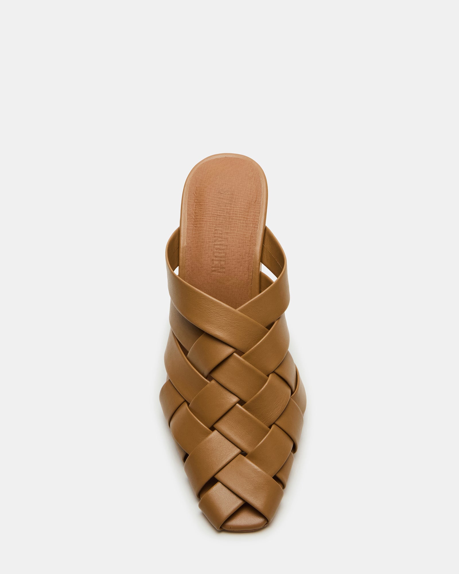 Top view of white mule heels showing woven texture and square toe design