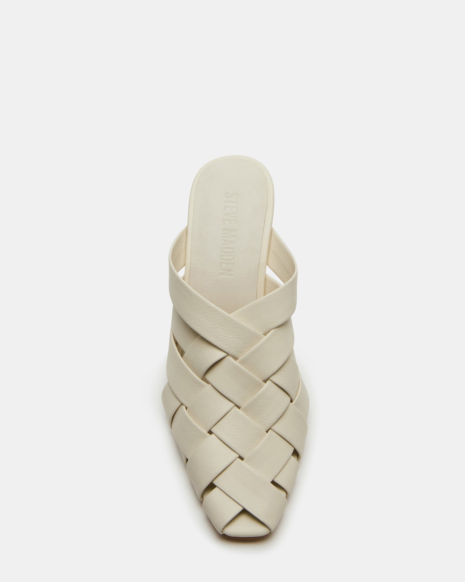 Front angle of NAKITA white mules showing square toe and woven texture