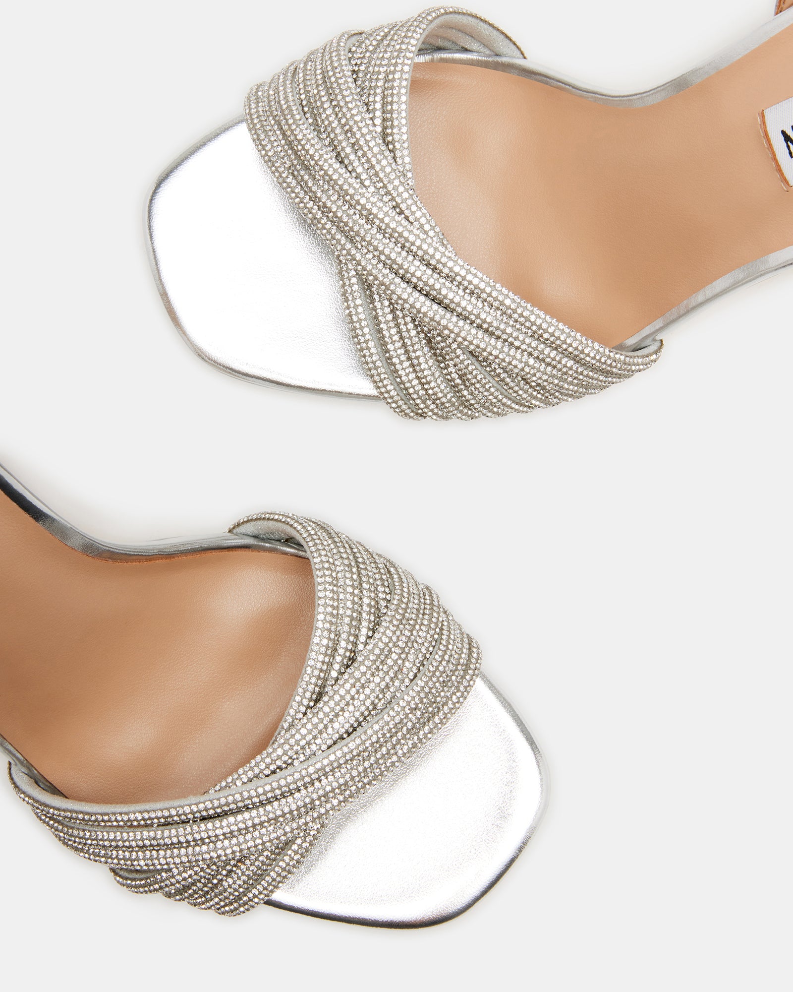 Close-up of NANI rhinestone heels showing crystal detailing on straps