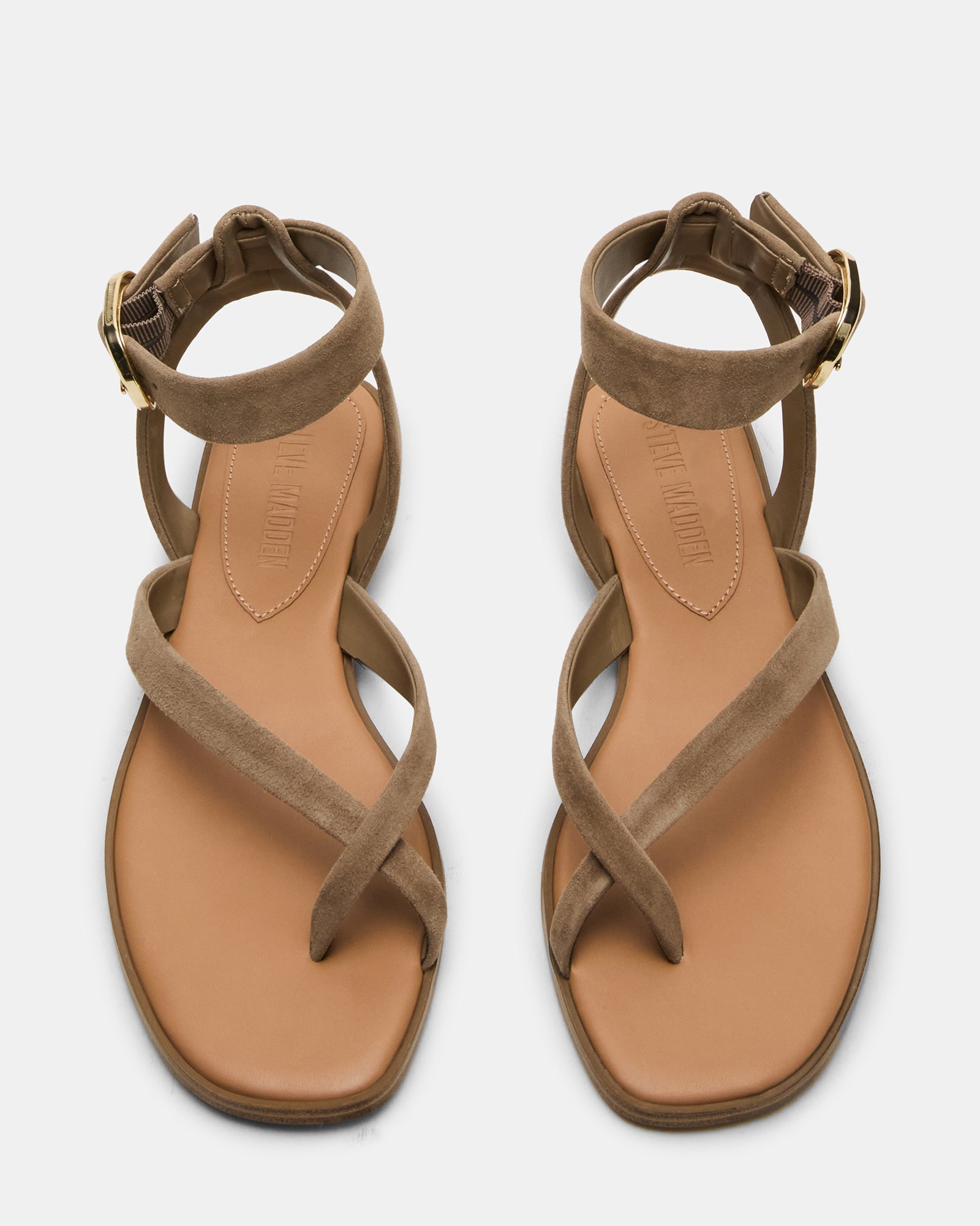 Close-up of black flat sandals ankle strap detail and suede texture for comfort