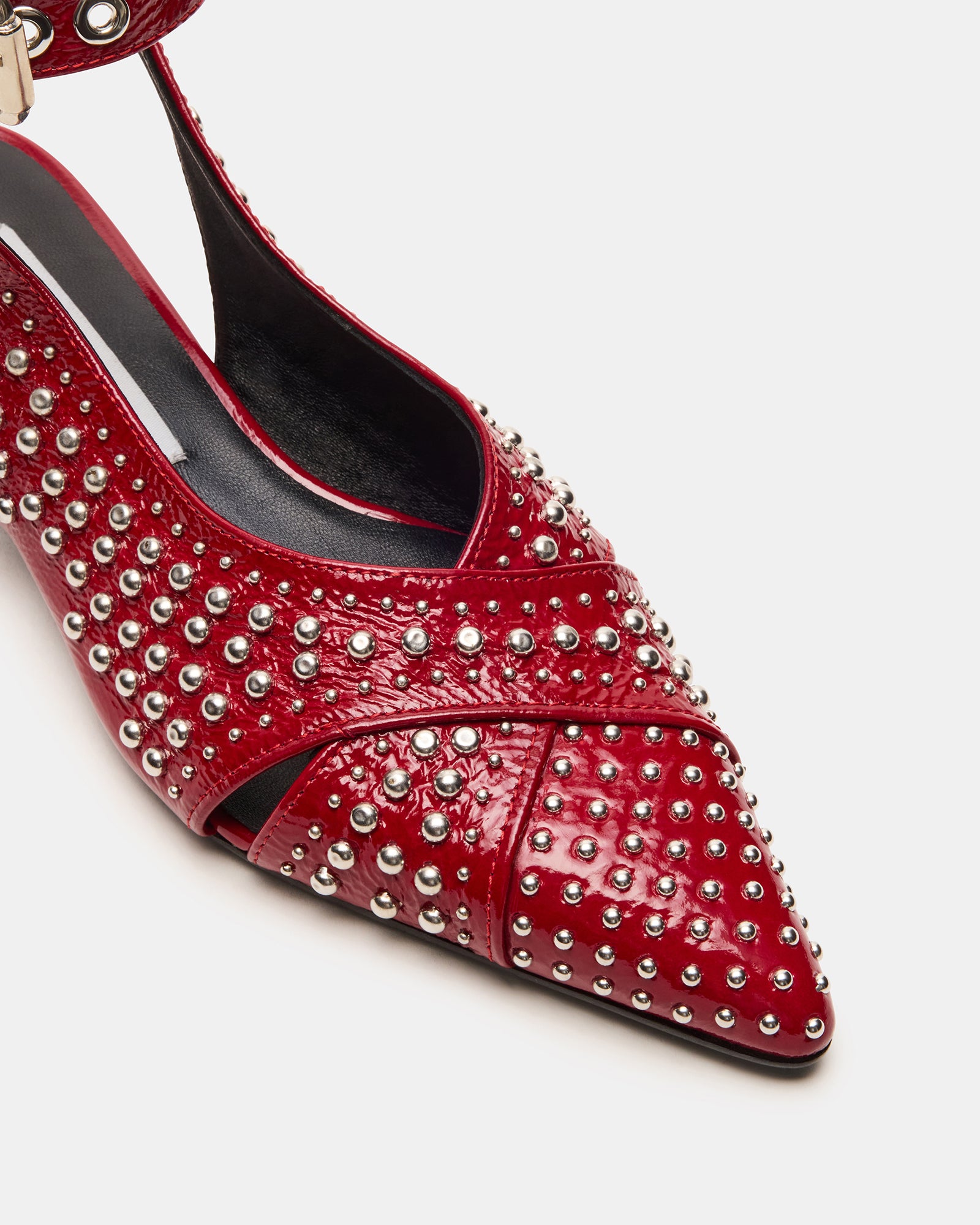 Side view of the red leather flats highlighting the slingback strap and heel